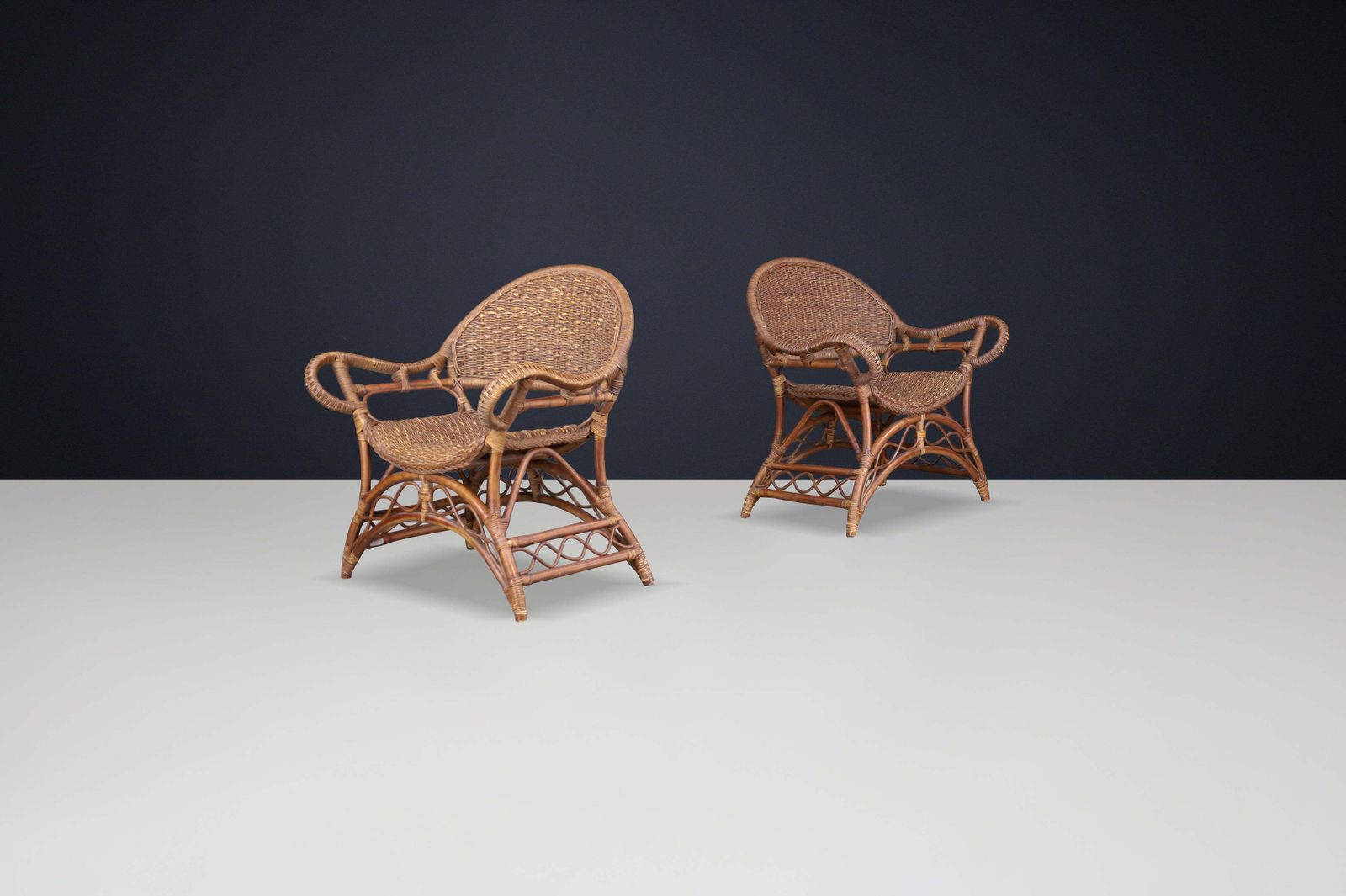 photo furniture Set Of Two Sculptural Rattan And Bamboo Lounge Chairs, Spain, 1960s