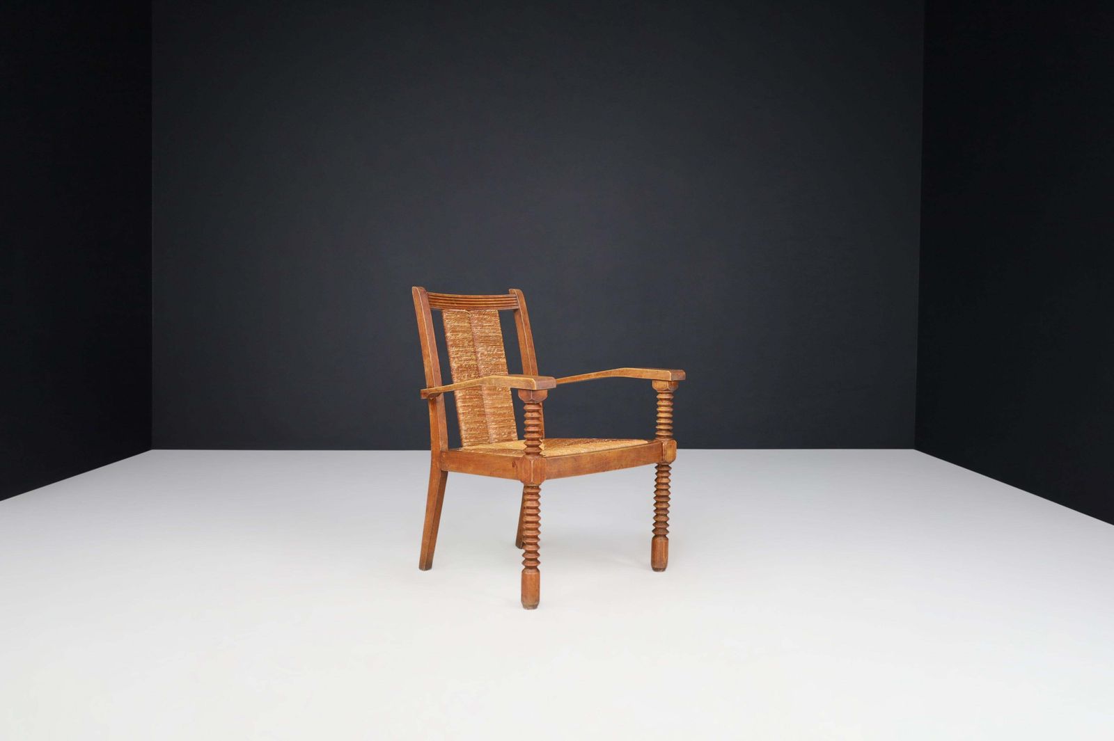 photo furniture Charles Dudouyt Patinated Oak And Rush Armchairs, France 1940s