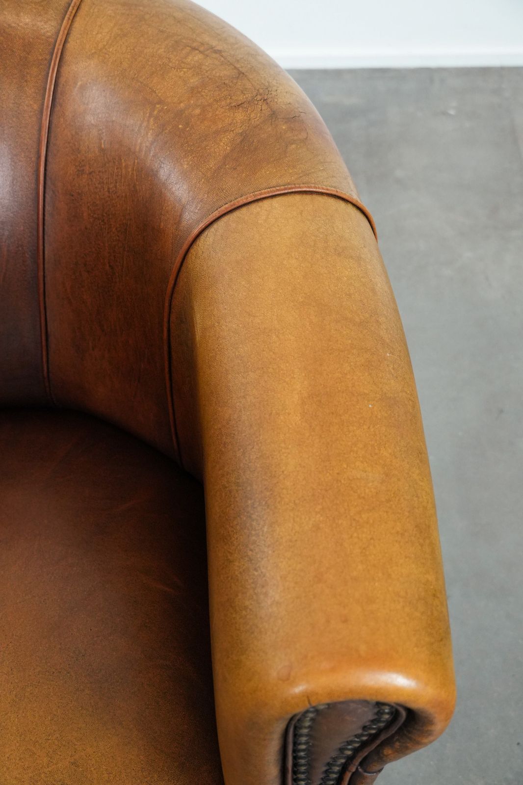Elegante Schapenvacht Club Fauteuil Met Warme Kleuren, Siernagels En Sierlijk Stiksel photo vintage