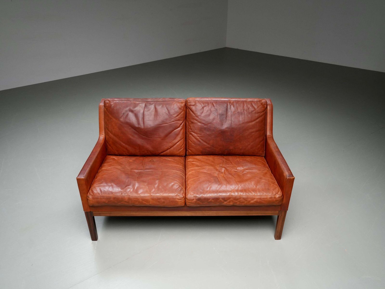 photo furniture Kai Lyngfeldt Larsen 2 Seat Sofa In Cognac Patinated Leather, Denmark, 1960’s