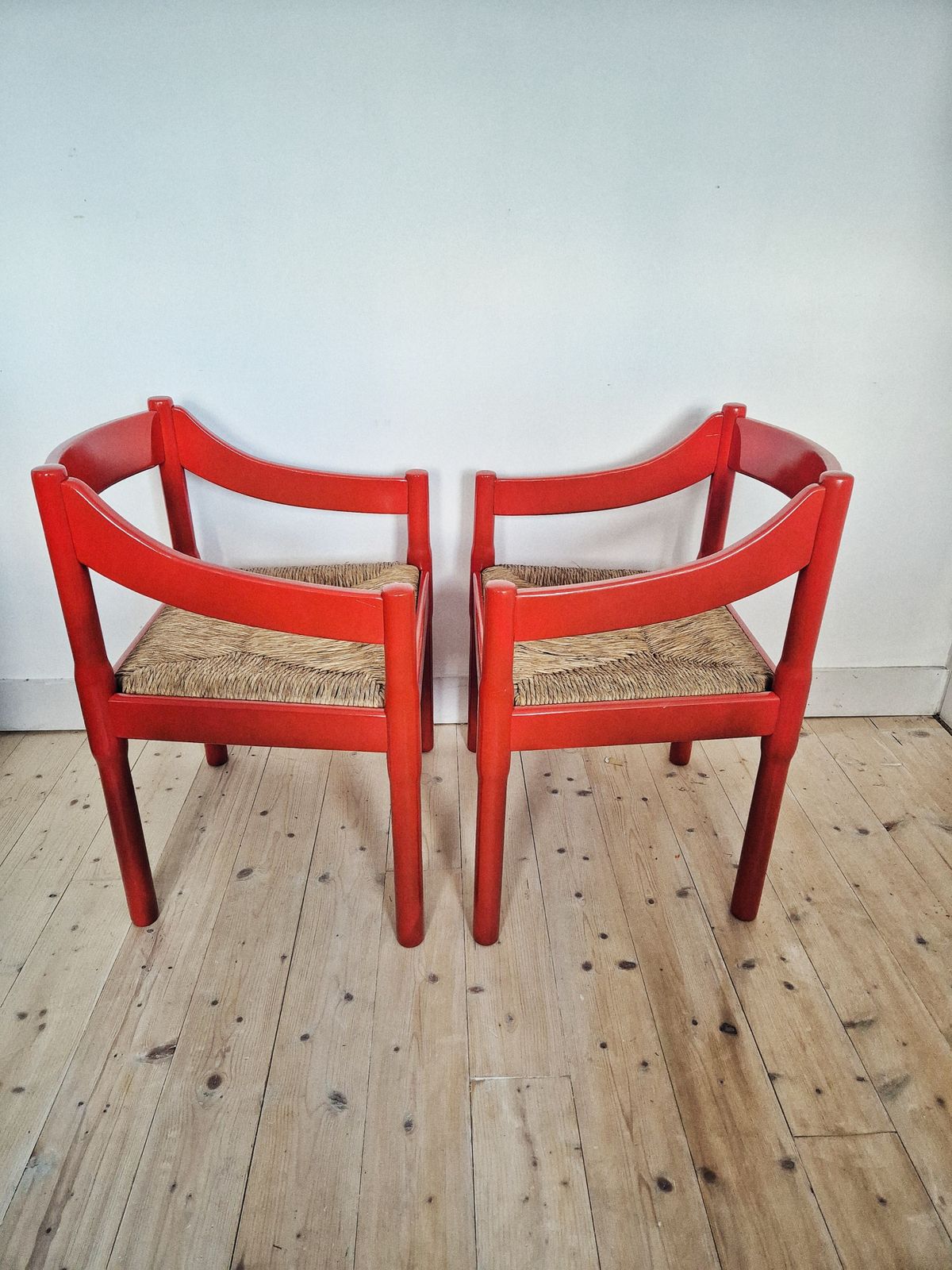 A Pair Of Red Vico Magistretti Carimate Carver Chairs photo for sale