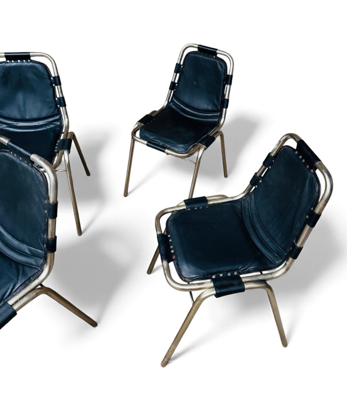 photo furniture Set Of Four Les Arcs Steel And Leather Dining Chairs Charlotte Perriand Style