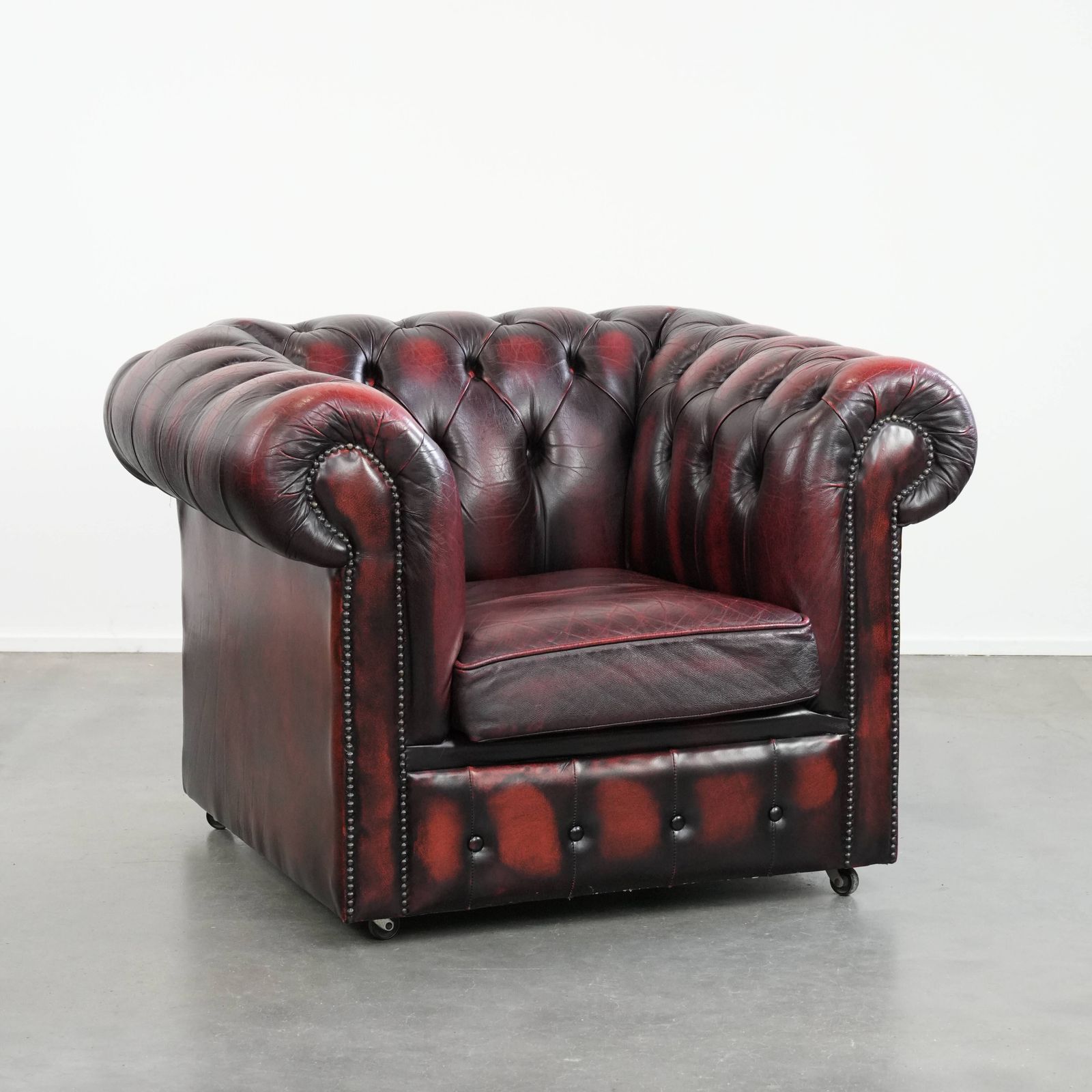 Timeless And Classic English Chesterfield Leather Armchair On Wheels, Finished With Decorative Nails