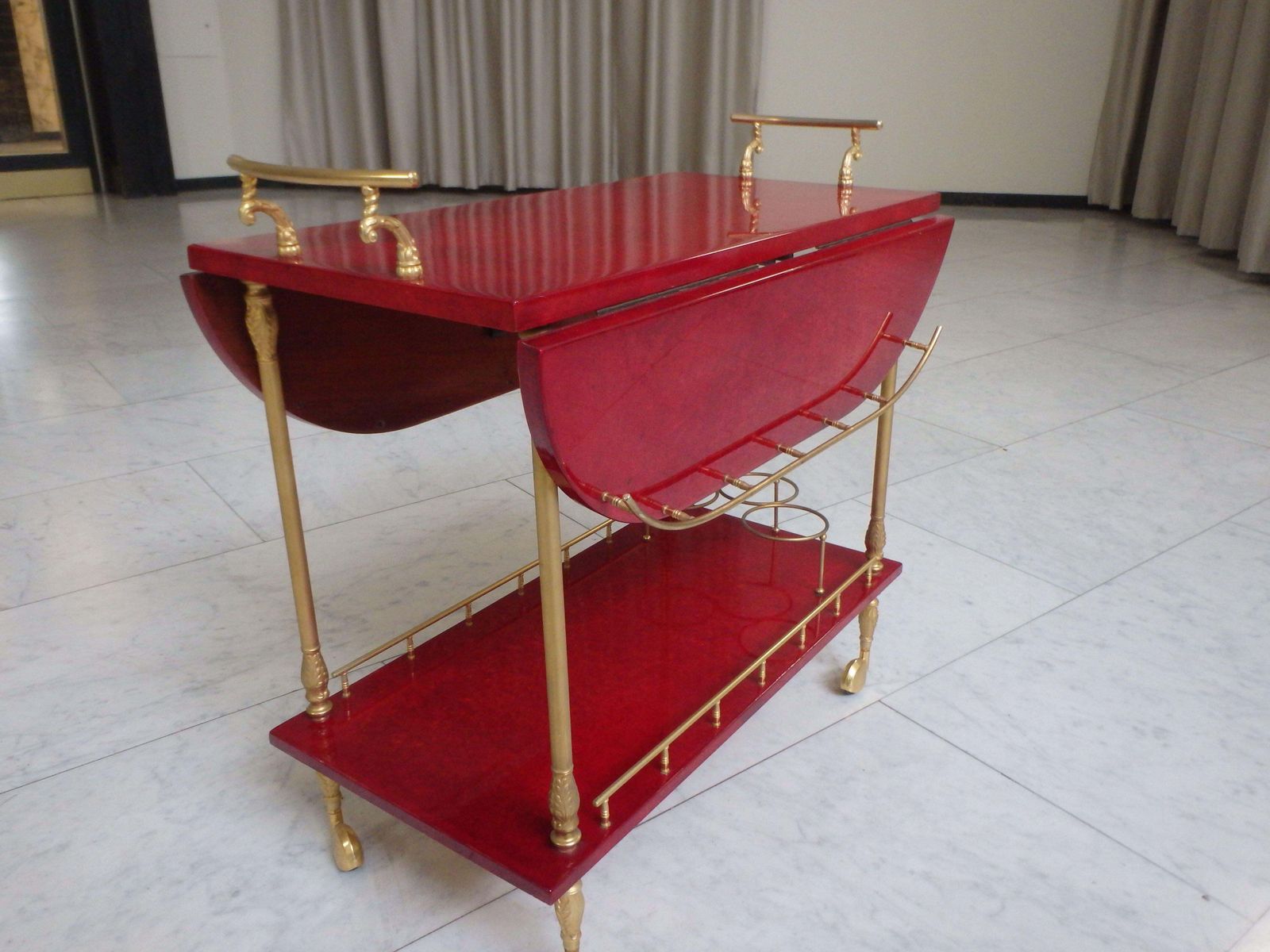 photo furniture Vibrant Red Coat Skin Bar Cart By Aldo Tura With Wings To Be Opend
