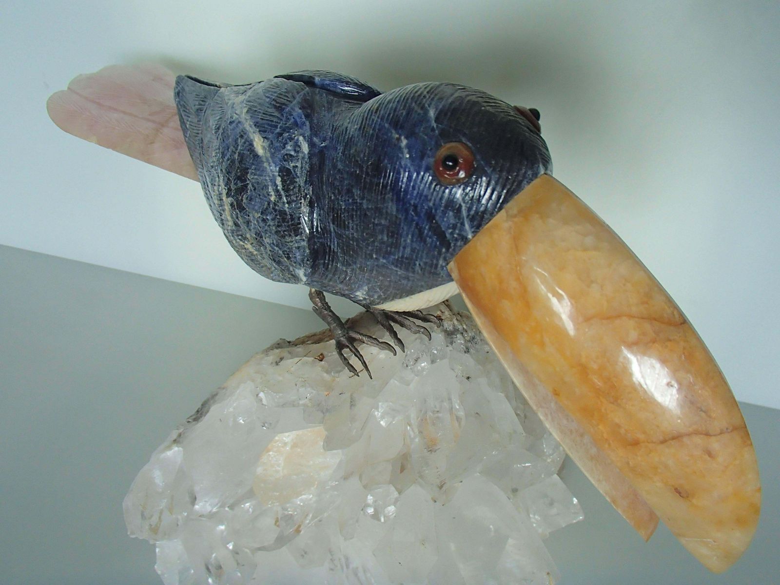 Tucan Sitting On A Cristall Made Of Sodalith And Rose Quarz photo vinterior