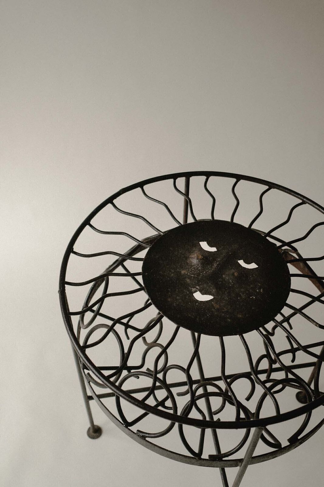 Sculptural Iron Table With Sunburst Face photo furniture