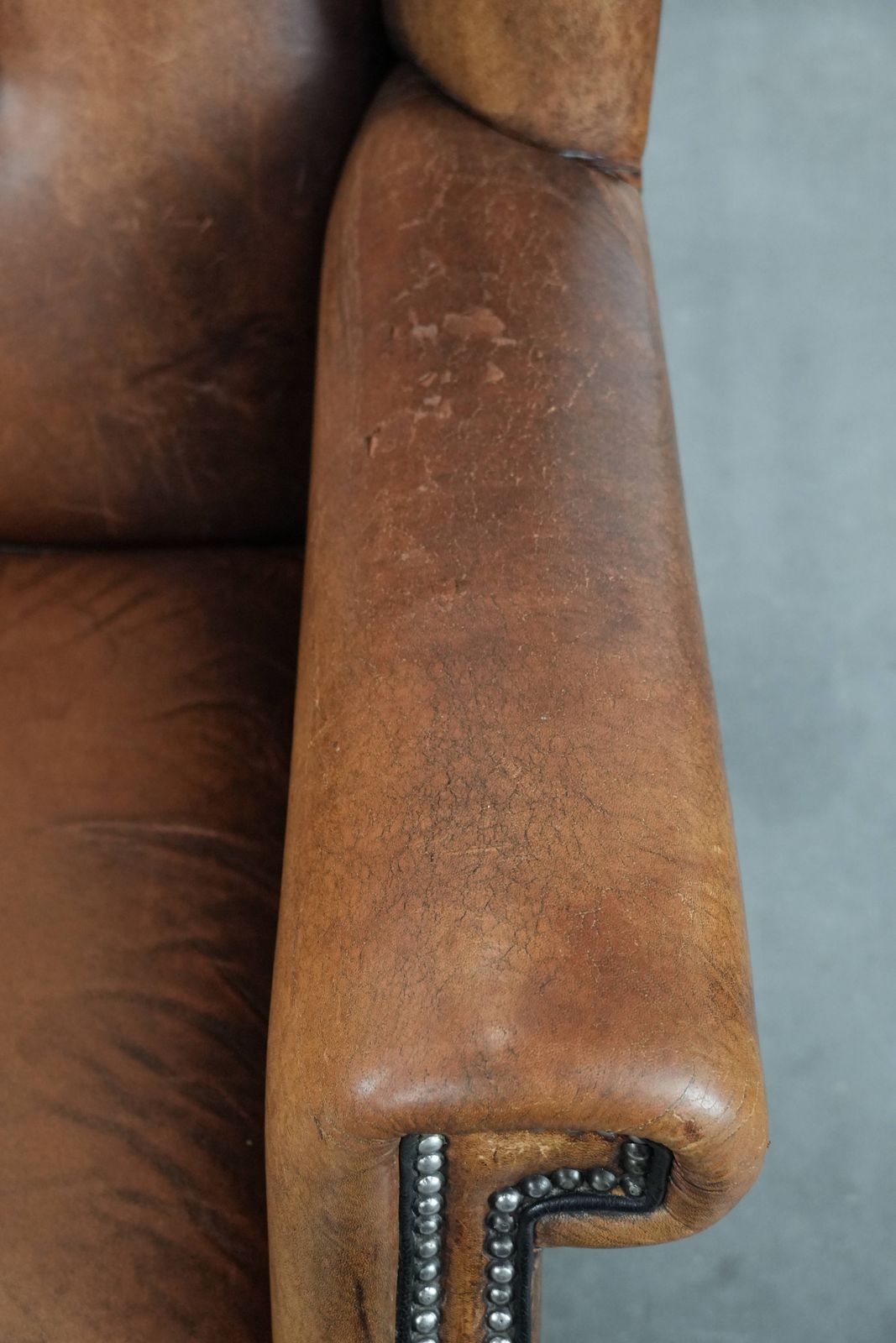 Large And Comfortable Sheepskin Wing Chair With A Characterful Look With Black Piping And Decorative Studs photo vintage