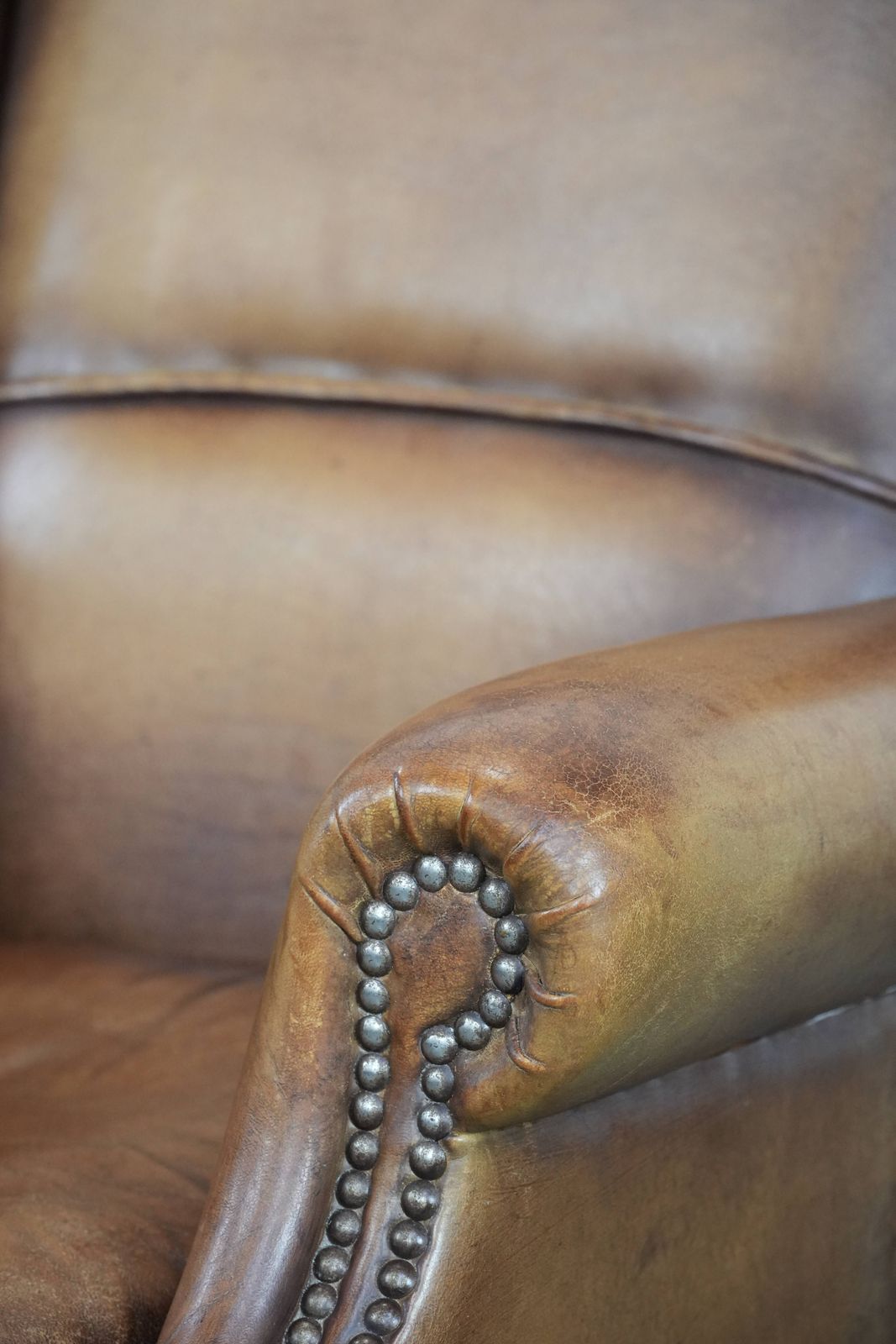 photo for sale Charming Sheepskin Wing Chair With Warm Colours Finished With Decorative Studs