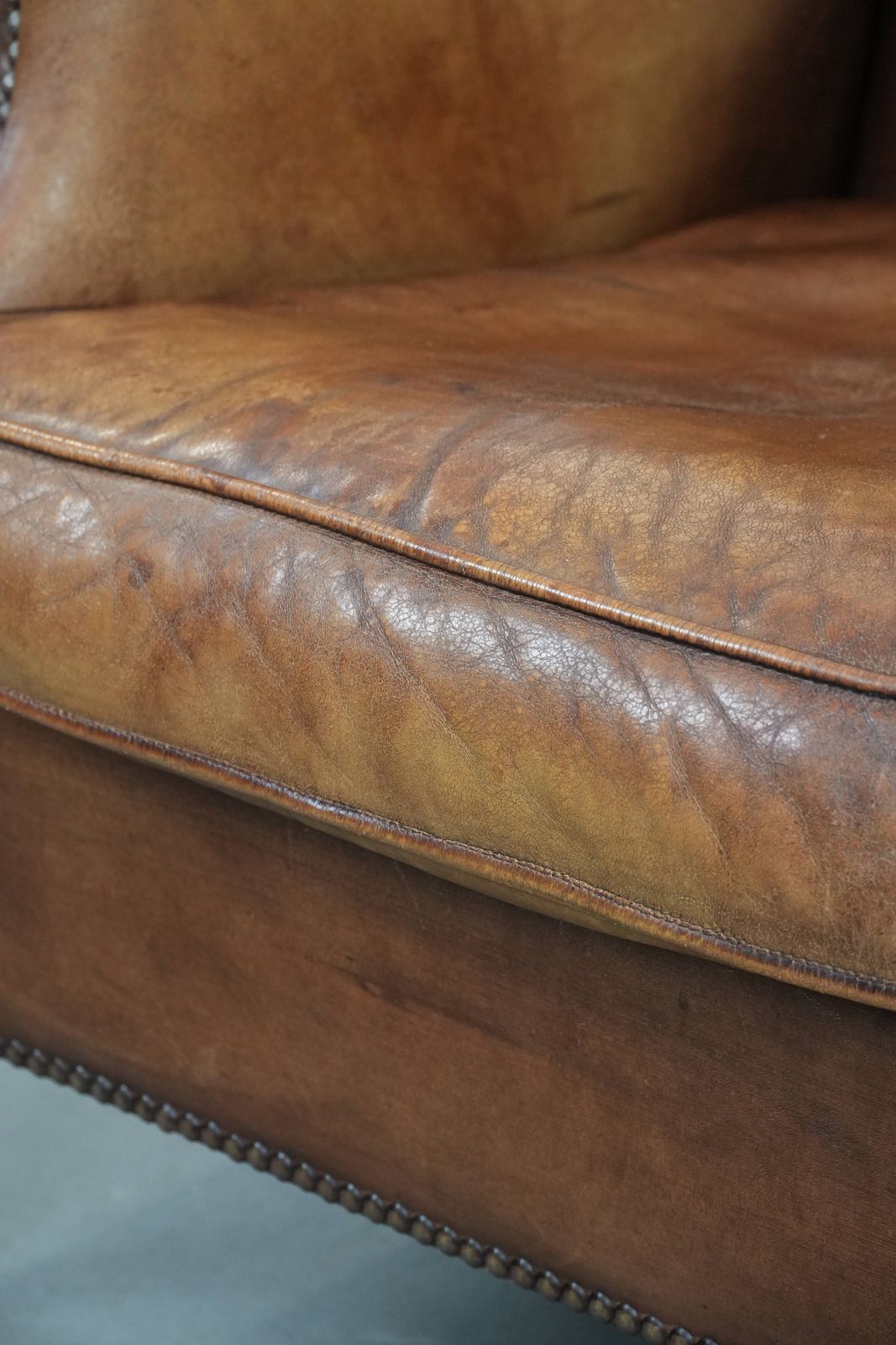 935.0 Charming Sheepskin Wing Chair With Warm Colours Finished With Decorative Studs photo