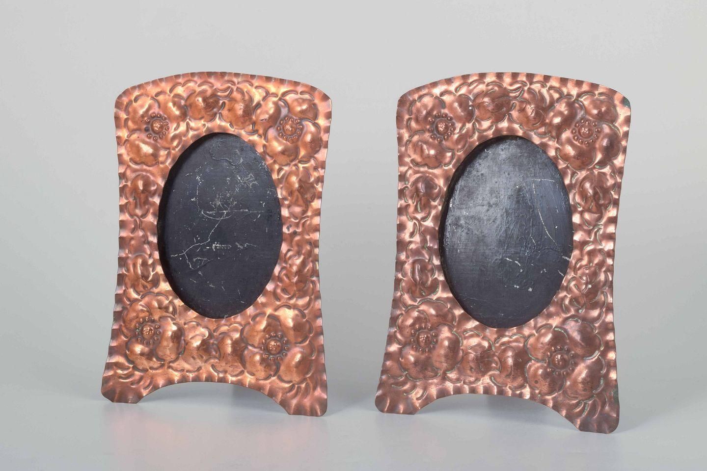 Two Decorative Picture Frames In Embossed Copper With Floral Motifs.