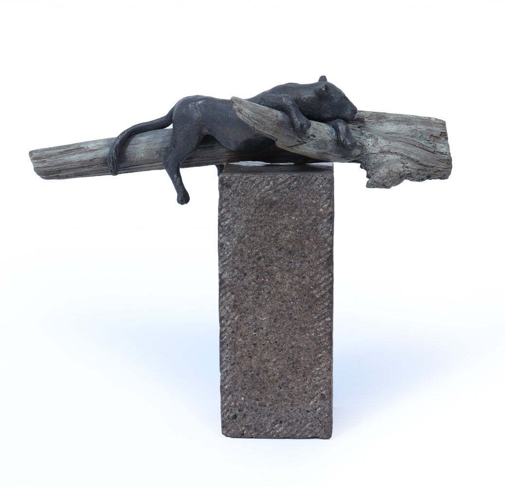 Bronze Sculpture Of A Resting Lioness On Cold Painted Log photo furniture