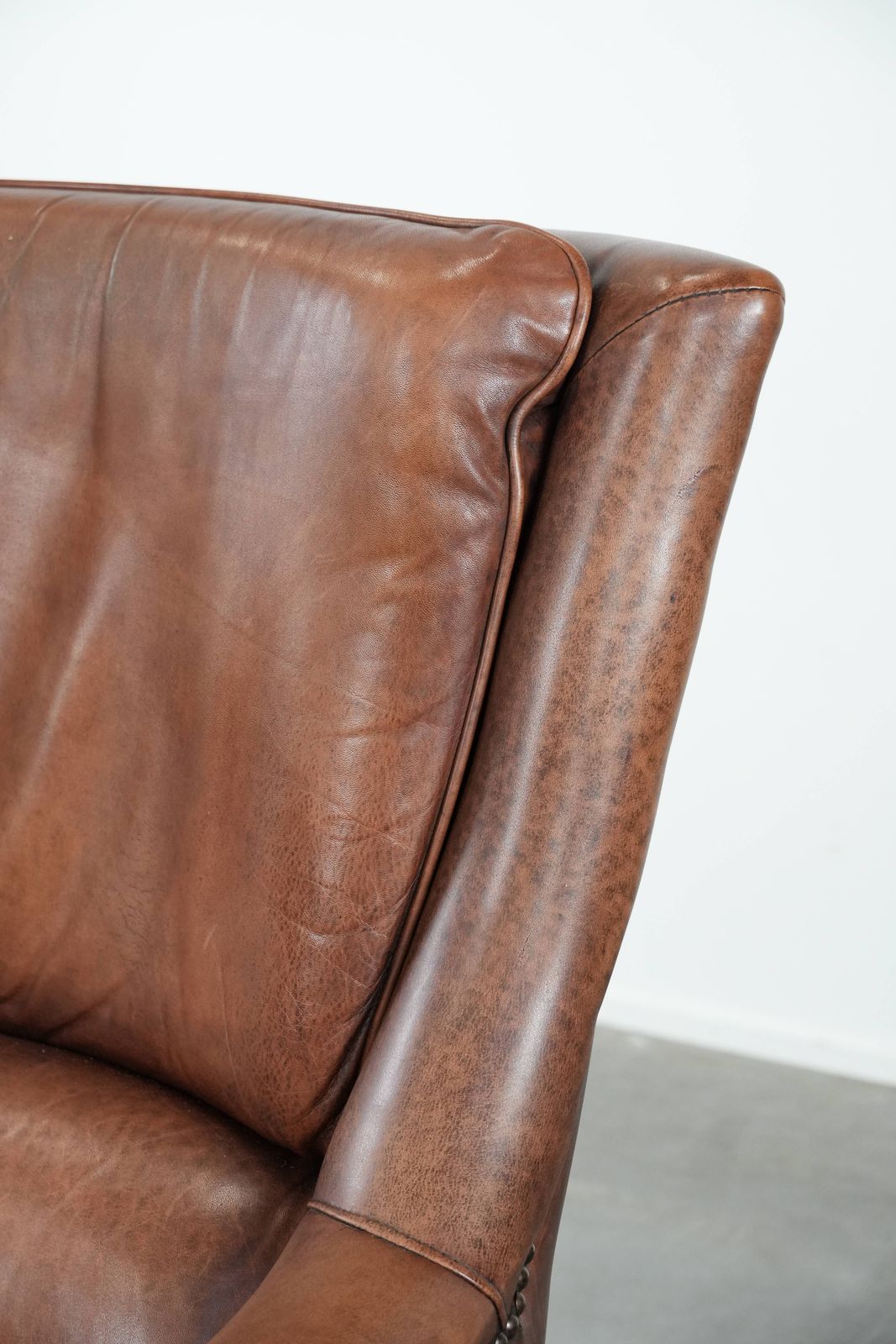 photo furniture Very Comfortable And Luxurious Cognac Brown Cowhide Armchair With A Decorative Stud Finish