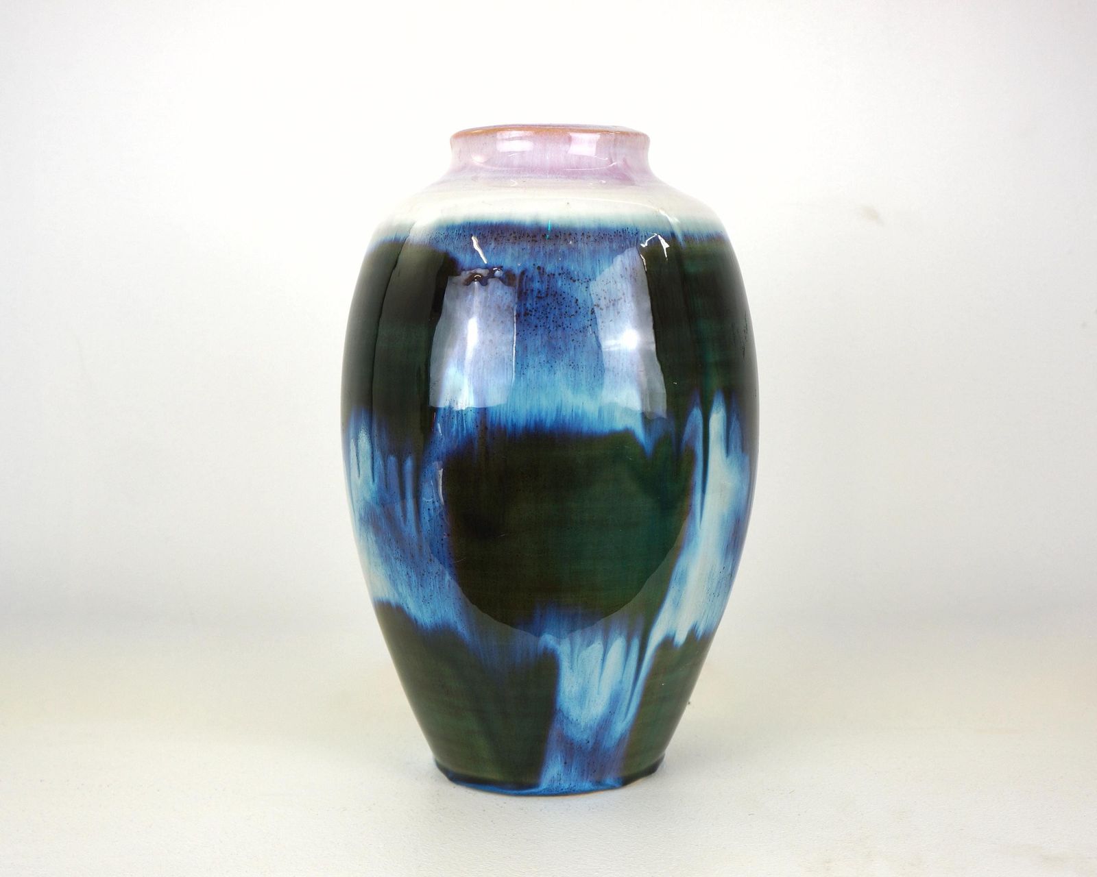 A Mid Century Blue Flambe Glazed Pottery Vase With Pink Rim photo furniture