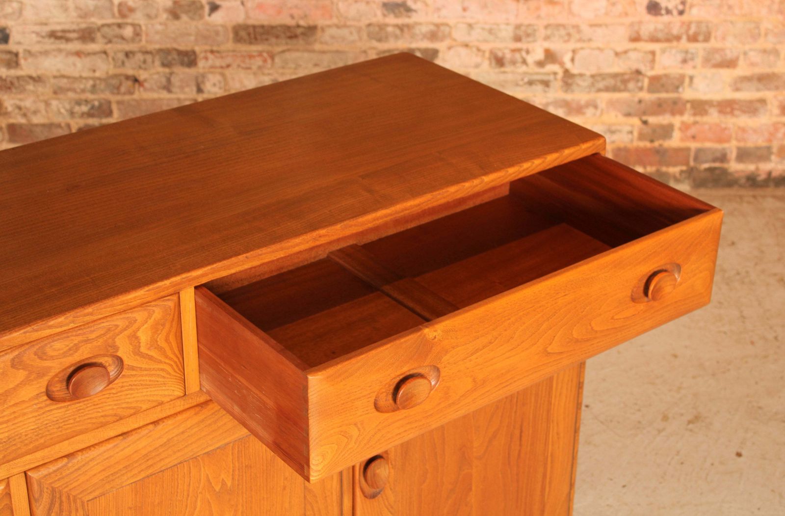 photo furniture Mid Century Ercol Windsor Solid Elm Sideboard On Casters, Circa 1960s