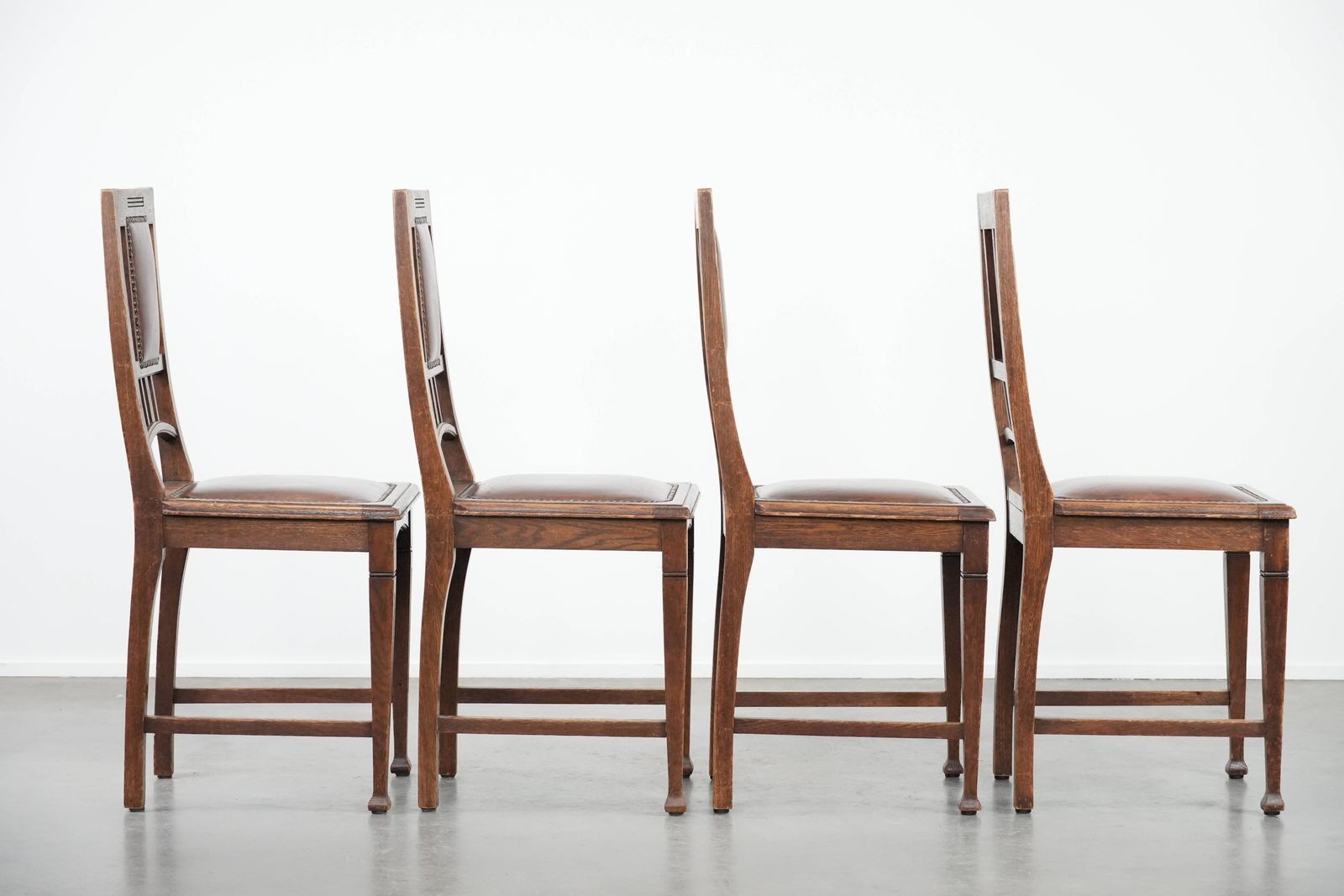 Set Of Four Antique Oak Dining Chairs In Art Nouveau Style With Cognac Colored Cowhide photo for sale