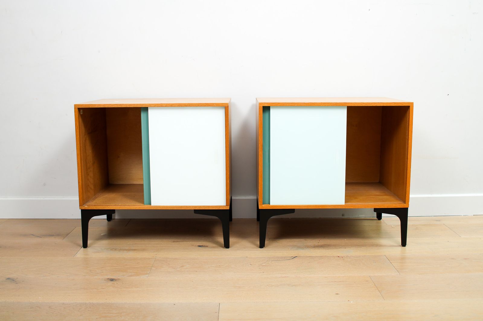 A Pair Of Vintage Mid Century Bedside Tables With Glass Sliding Doors photo vintage