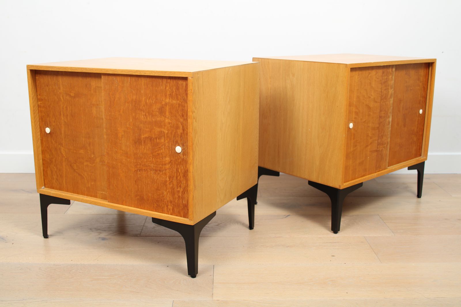 A Pair Of Vintage Mid Century Bedside Tables With Oak Sliding Doors photo for sale