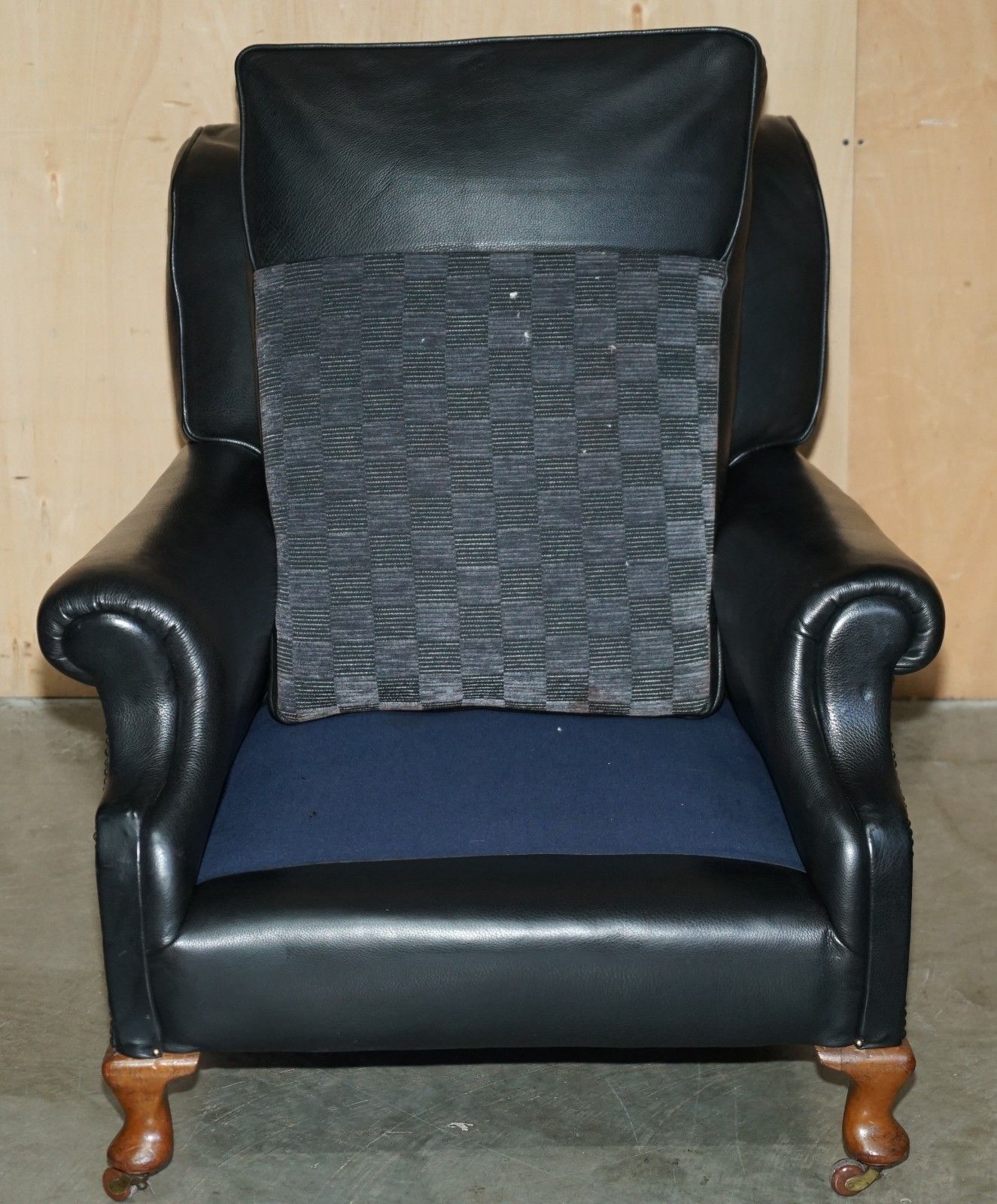 photo vintage Oversized Antique Victorian Black Leather Club Armchair Stamped Inside Back Leg