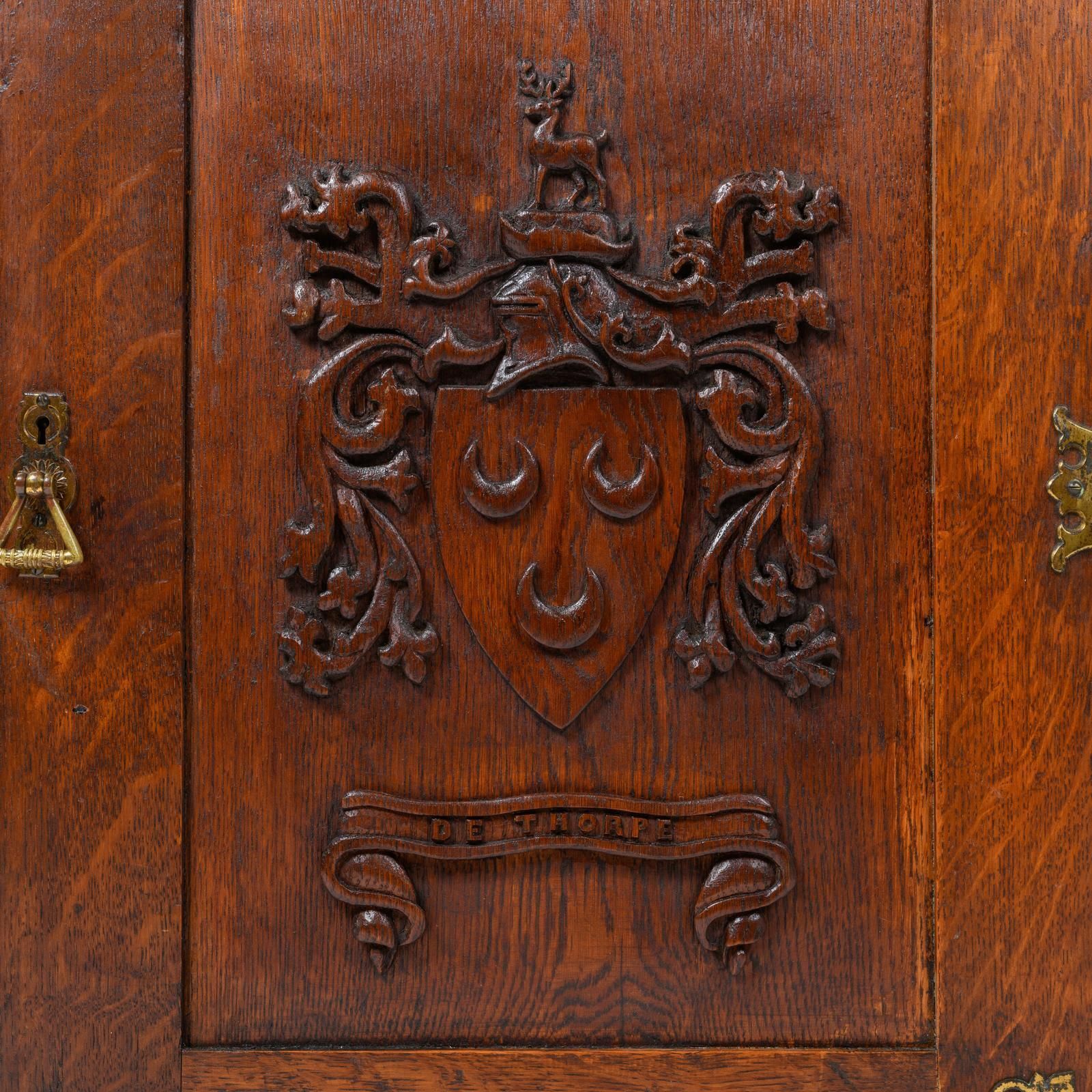 An Arts And Crafts Oak Corner Cabinet, Dated 1908, With The Crest Of The De Thorpe Family photo buy