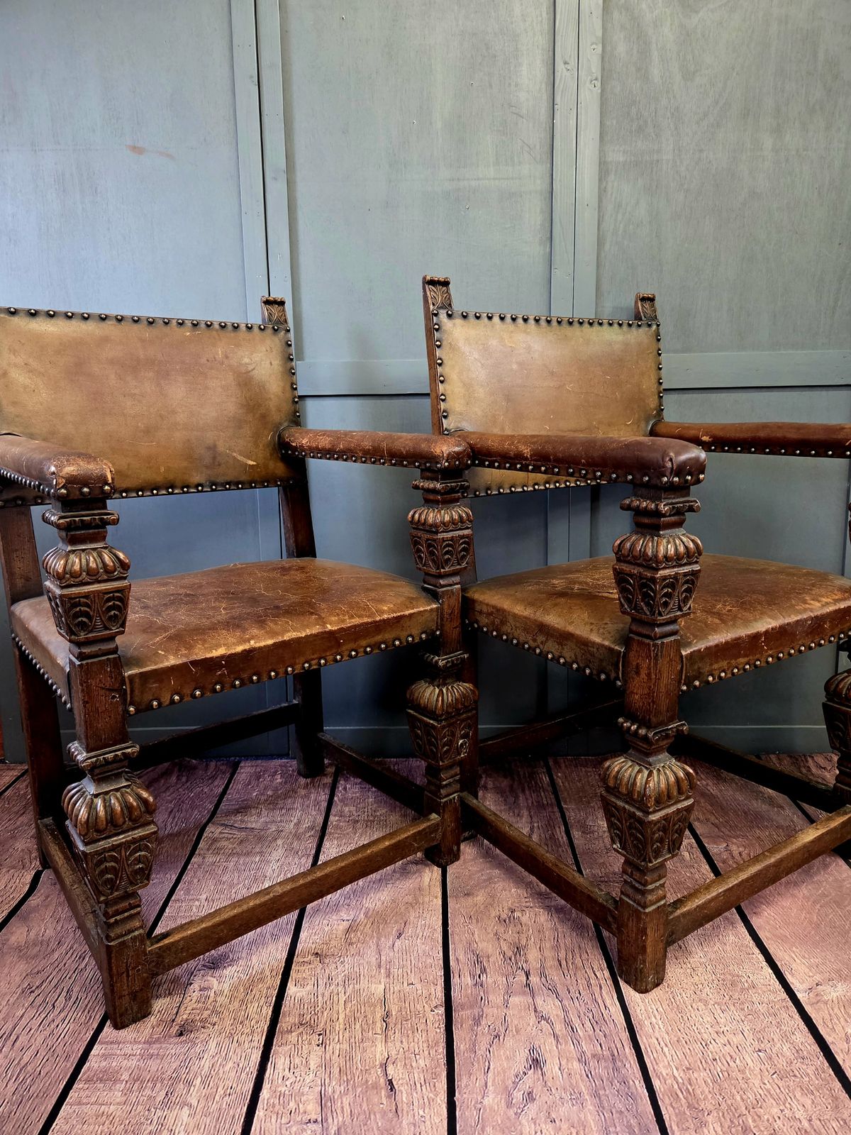 Pair Of Late 19th Century Jacobean Revival Carved Oak Armchairs With Original Studded Leather
