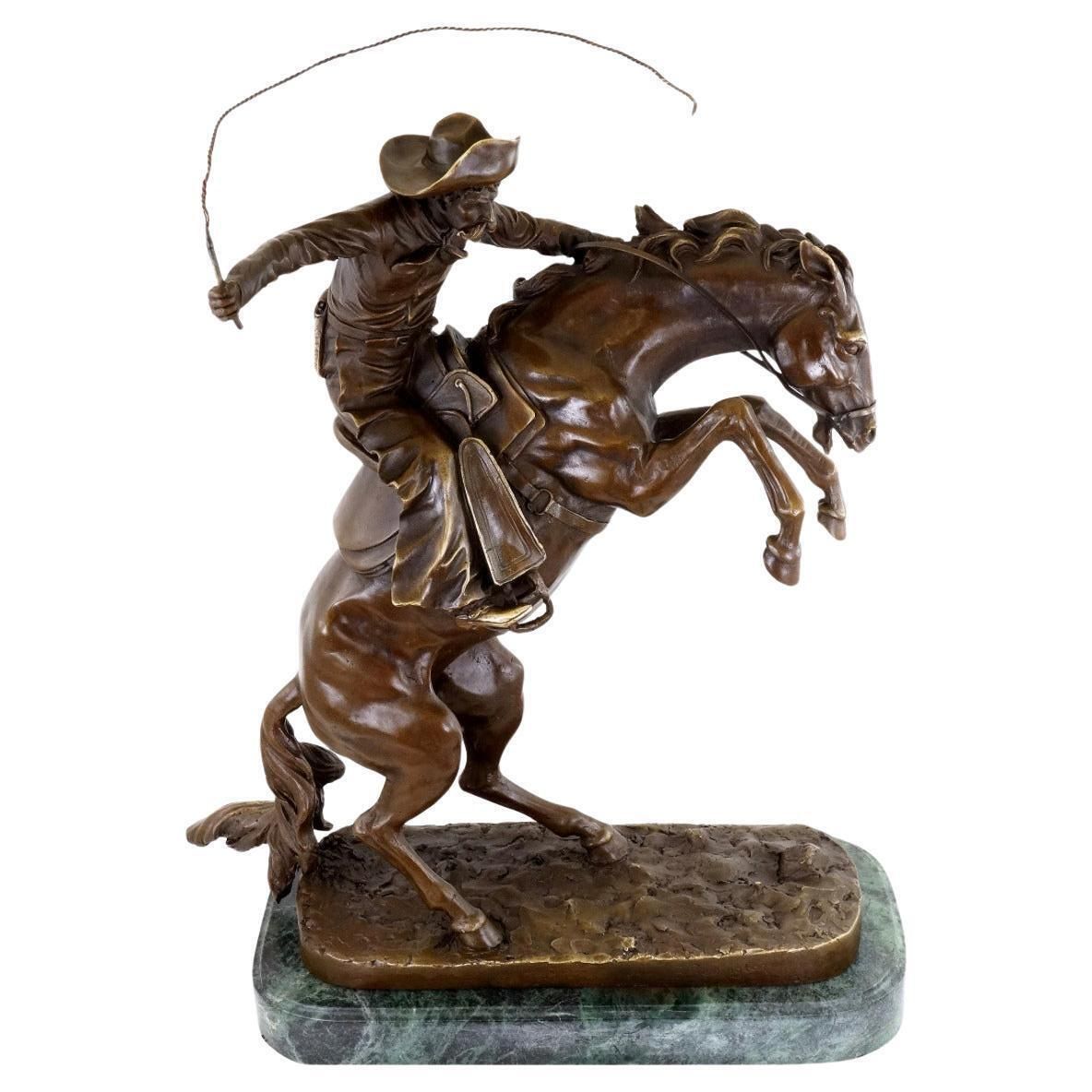 Western Bronze Sculpture Depicting A Cowboy On A Rearing Horse, 20th Century.