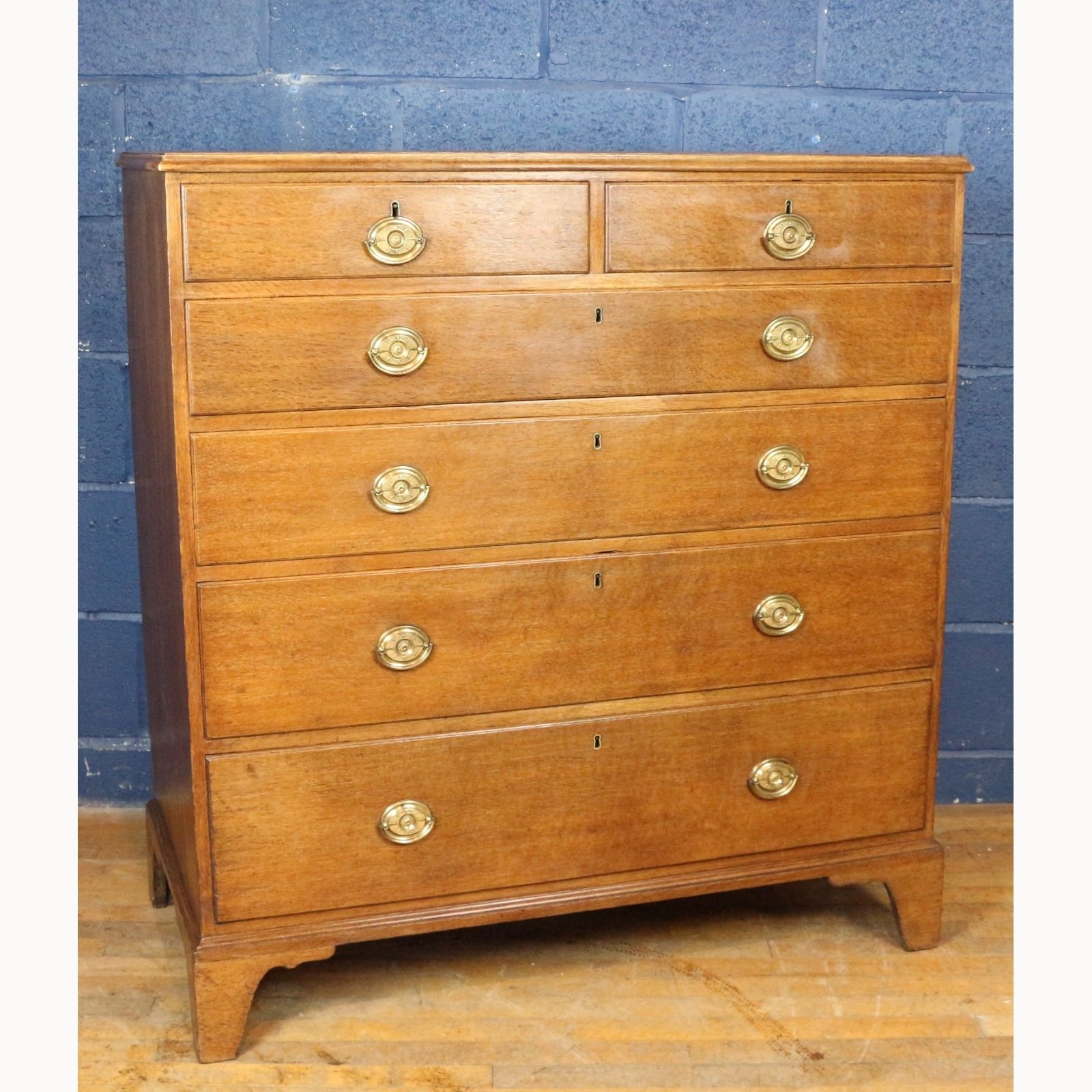A Georgian Oak Two Over Four Chest Of Drawers Raised On Bracket Feet