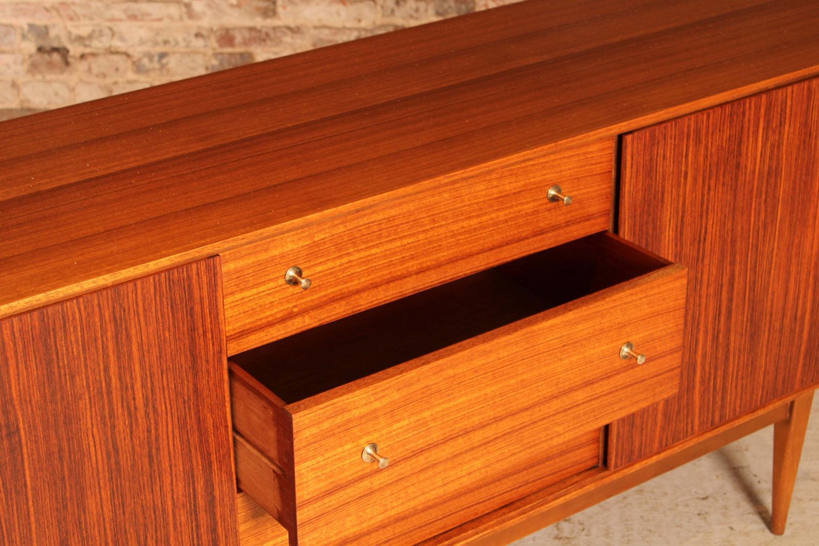 photo furniture Mid Century Teak And Rosewood Sideboard With Brass Handles By Wrighton, Circa 1960s