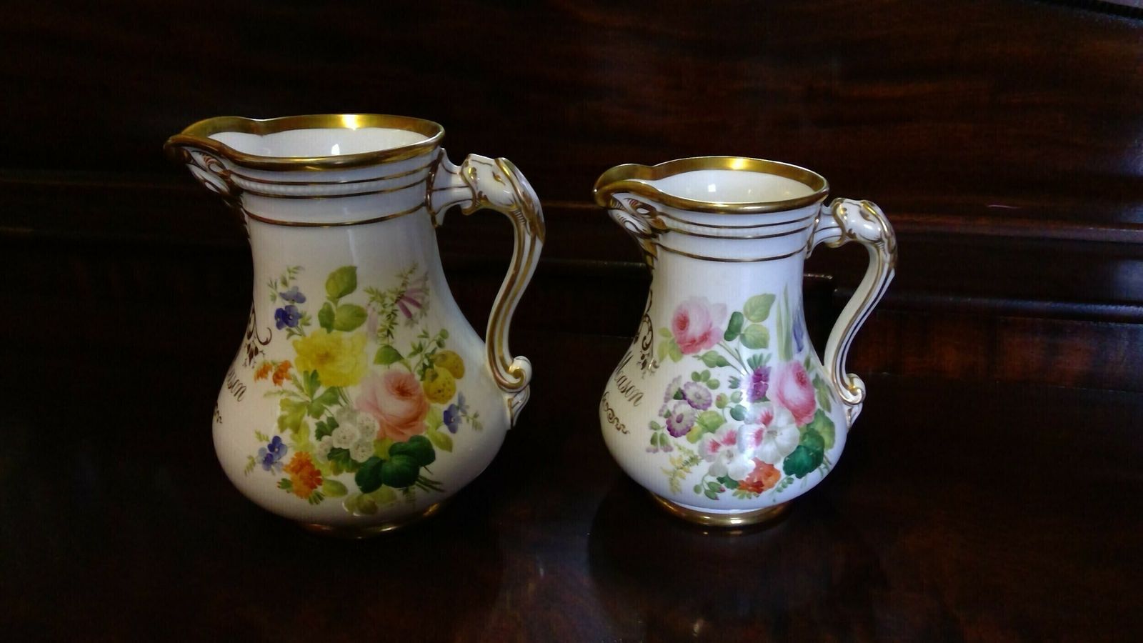 A Fine Quality Pair Of Rockingham Coalport Porcelain Botanical Floral Decorated Marriage Jugs Highlighted In Giltwork Dated 1860