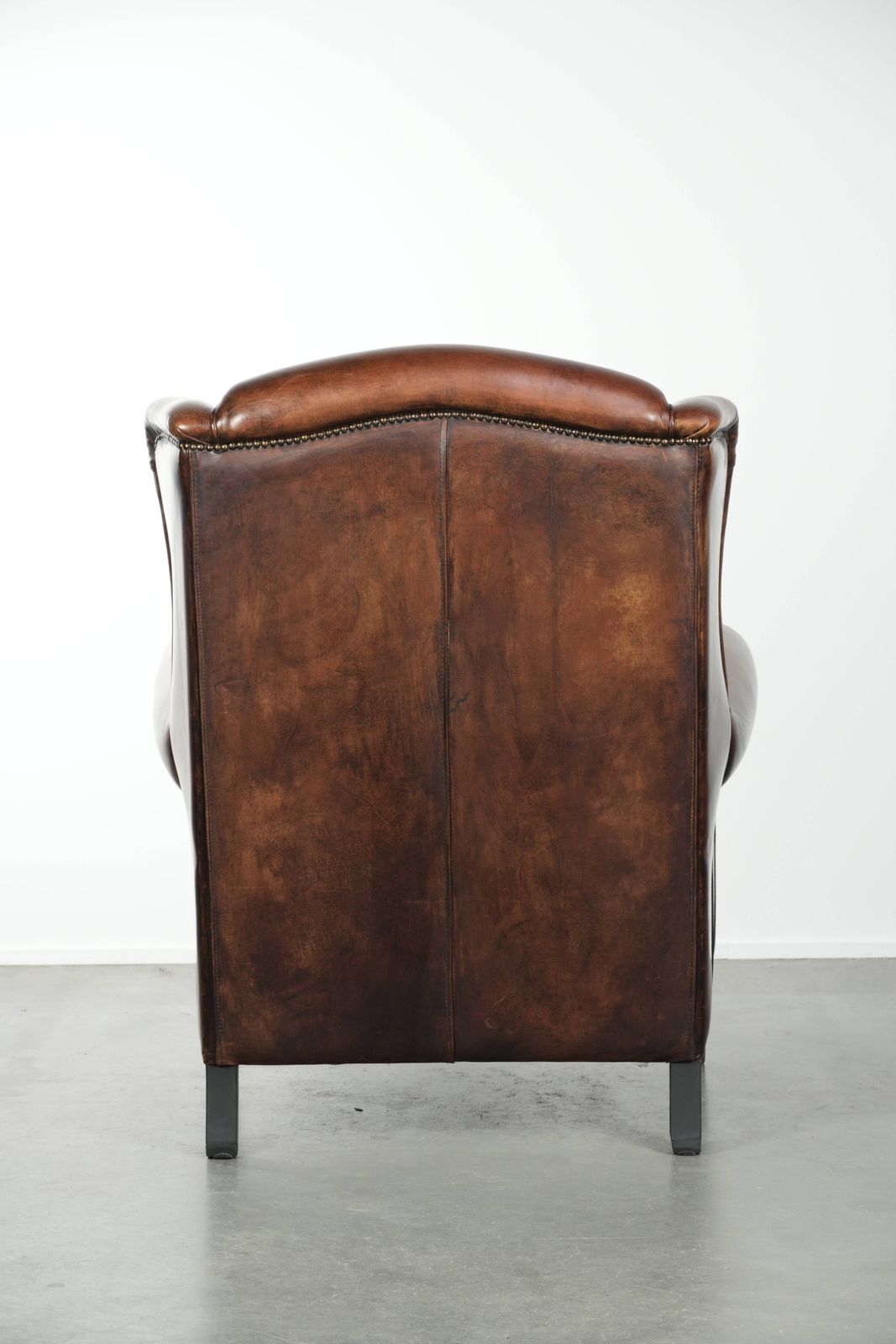 Beautiful Large And Comfortable Sheepskin Wing Armchair With Lovely Deep And Warm Colors And A Finish With Decorative Nails. photo Furniture