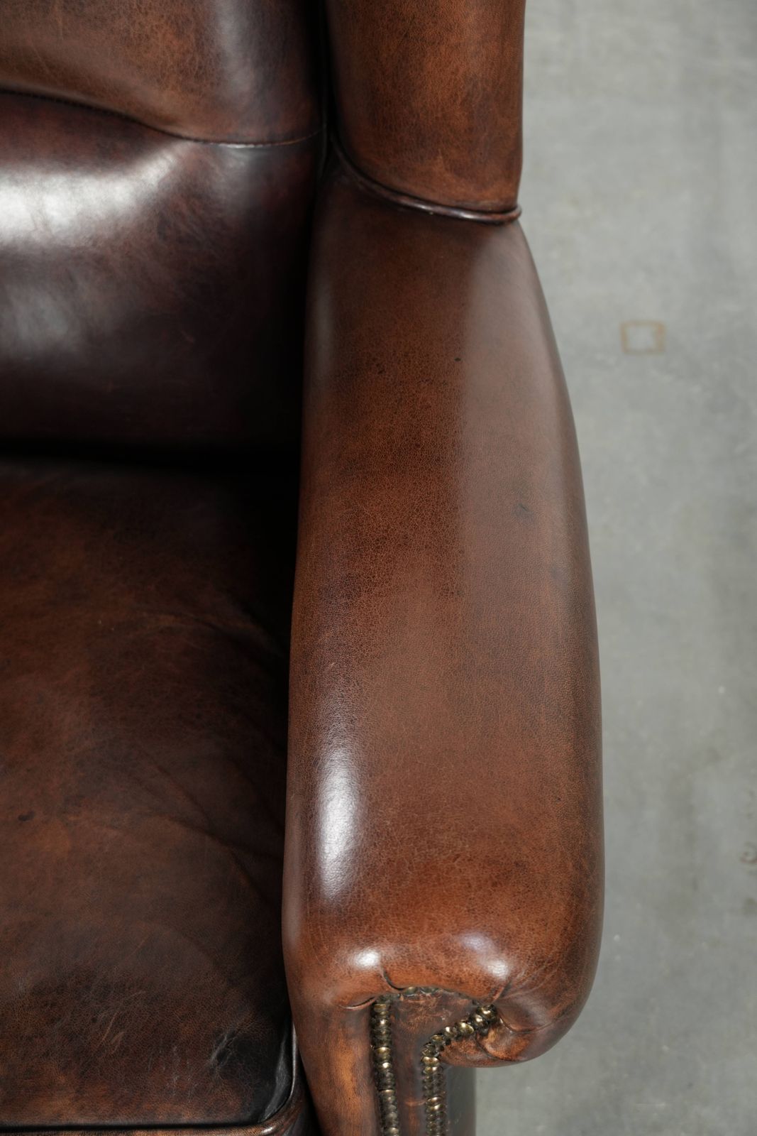 Beautiful Large And Comfortable Sheepskin Wing Armchair With Lovely Deep And Warm Colors And A Finish With Decorative Nails. photo vintage