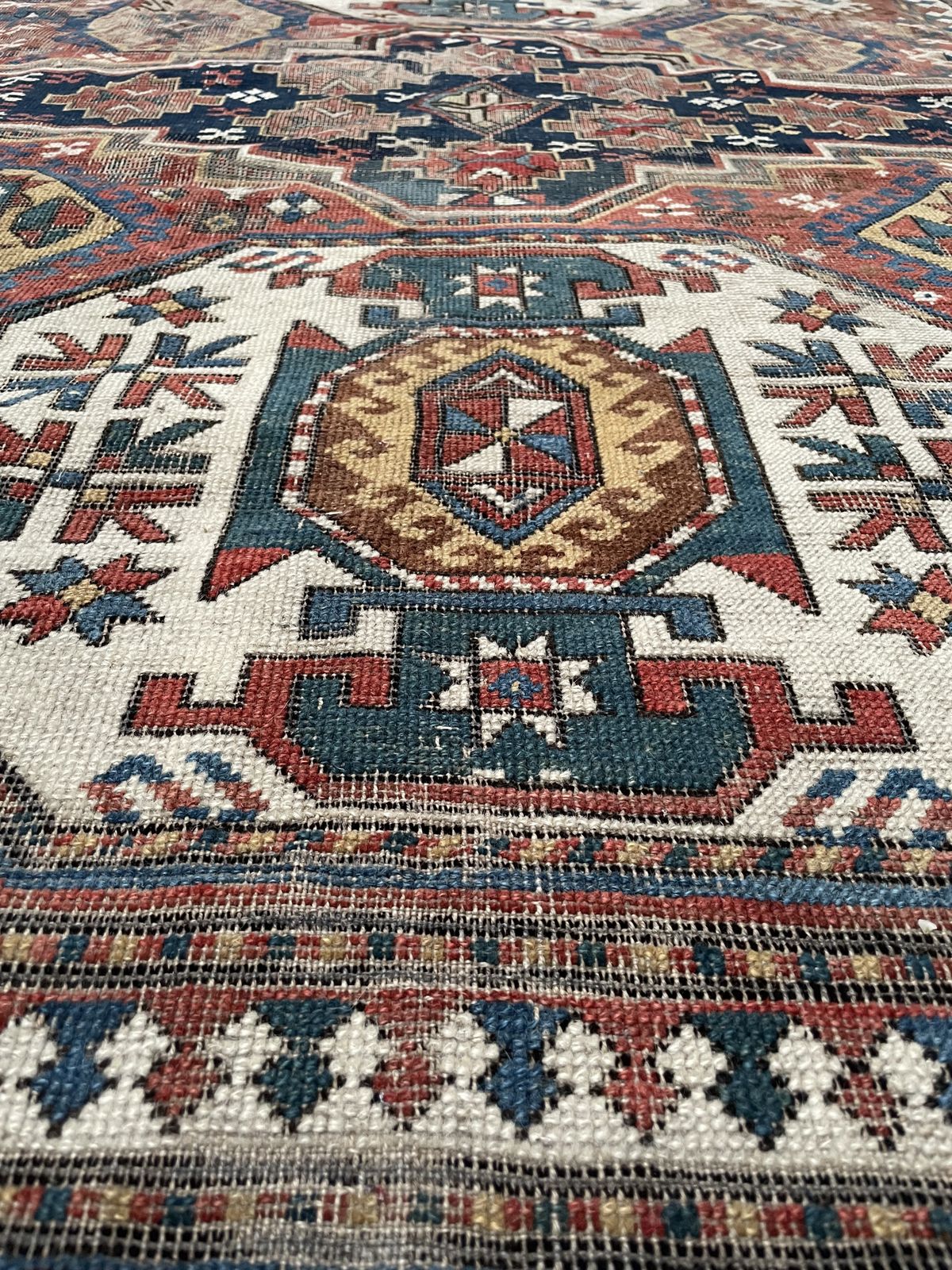 photo furniture Antique Caucasian Triple Medallion Kazak Rug