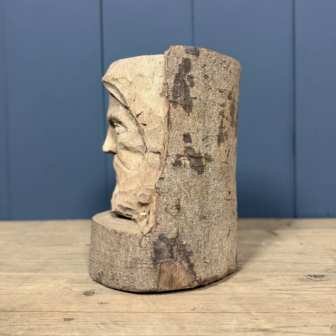 Head Of A Bearded Man Carved From A Wooden Trunk photo 171.0