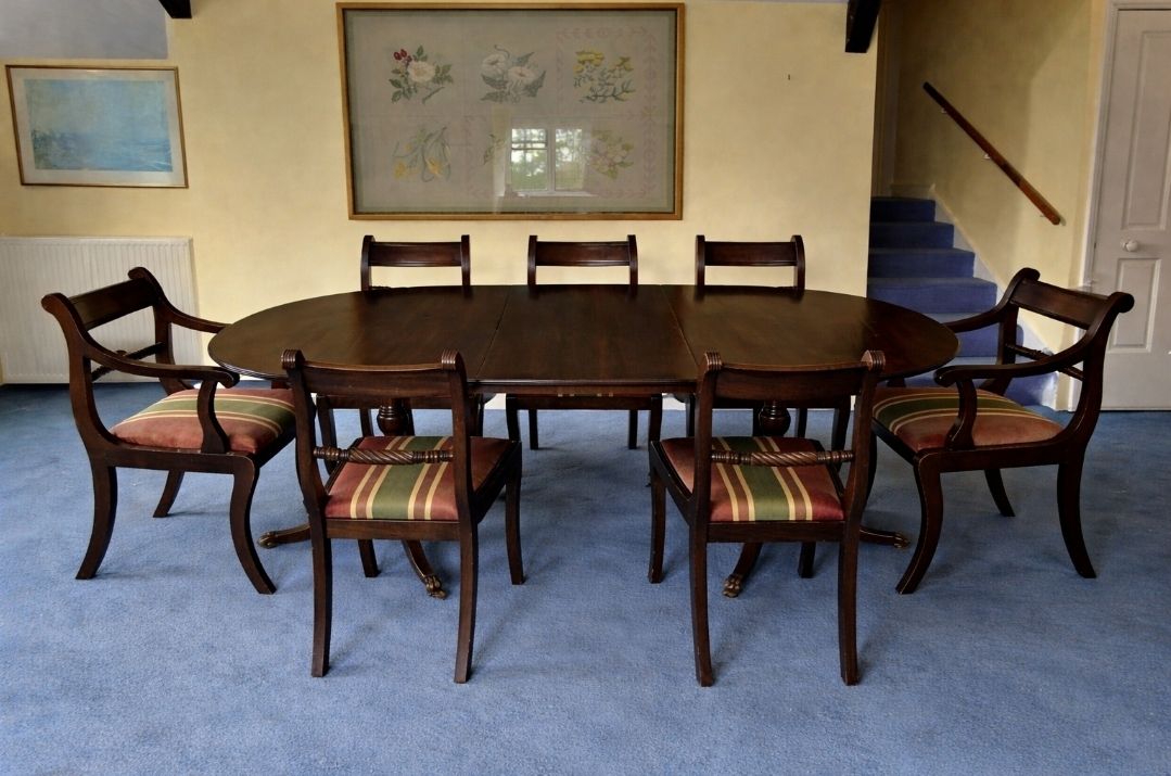 Regency Style Twin Pillar Dining Table With Removable Central Leaf.  Features Splayed Legs With Brass Castors Designed To Sit Up To 8 People.  Comes With 5 Chairs And 2 Carvers. photo 300.0