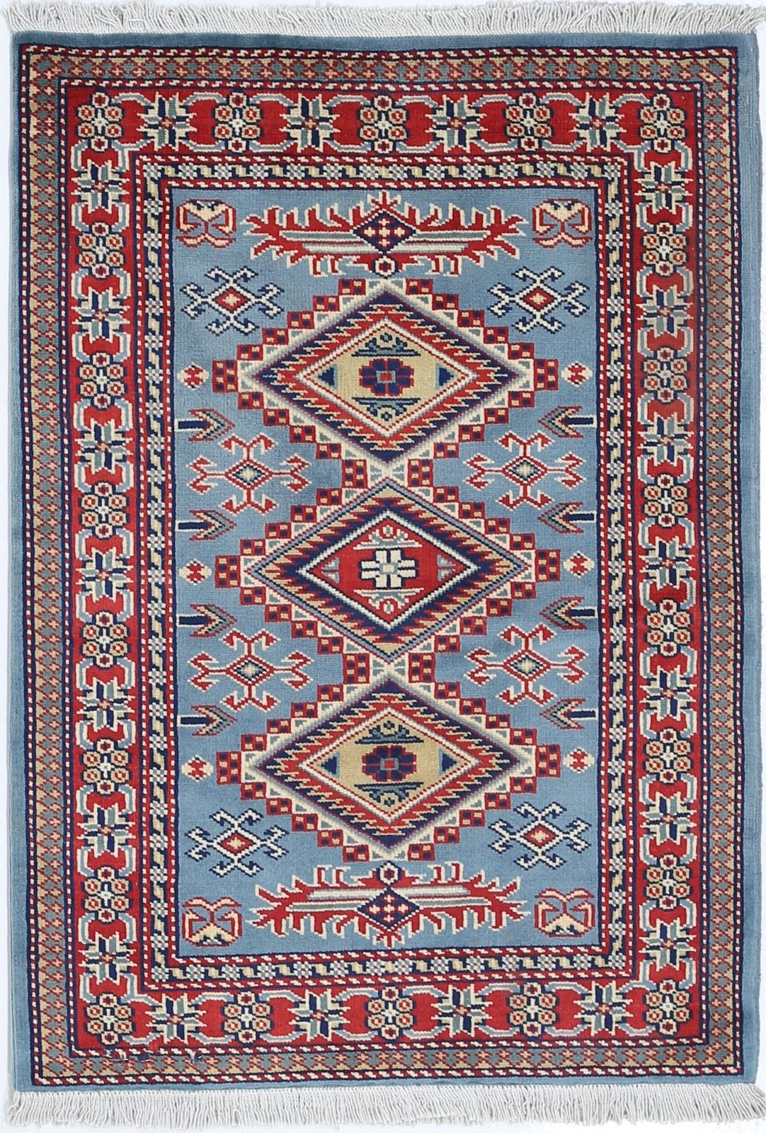 Tapis d'accent en laine fait main, bleu, rouge et ivoire, motif médaillon géométrique, 60 x 90 cm