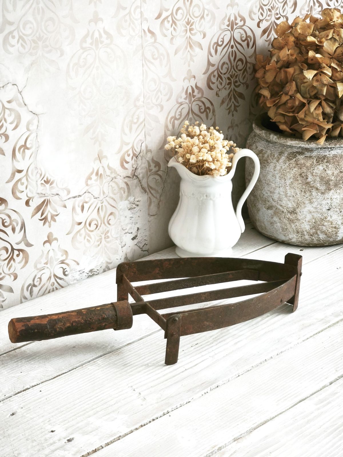 Antieke handgesmede ijzeren treeft met houten handvat