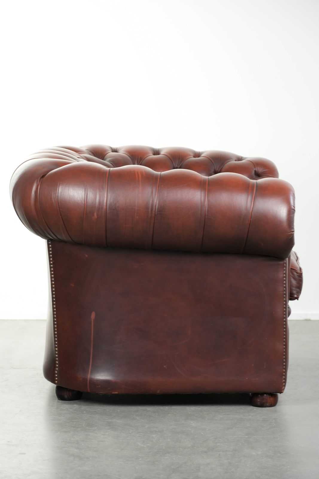 Beautiful Red/Brown Cowhide Chesterfield Armchair In A Classic English Style With A Stunning Appearance. photo for sale