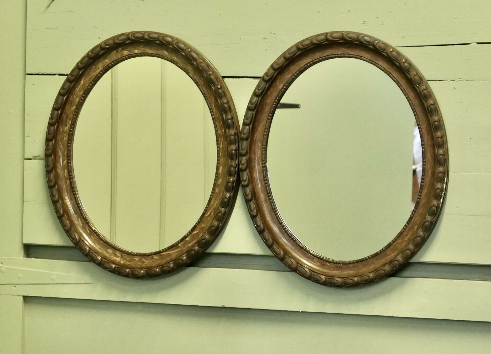 A Pair Of Simulated Wood Finish Oval Mirrors These Mirrors Have Very Attractive Wide Moul photo 780.0