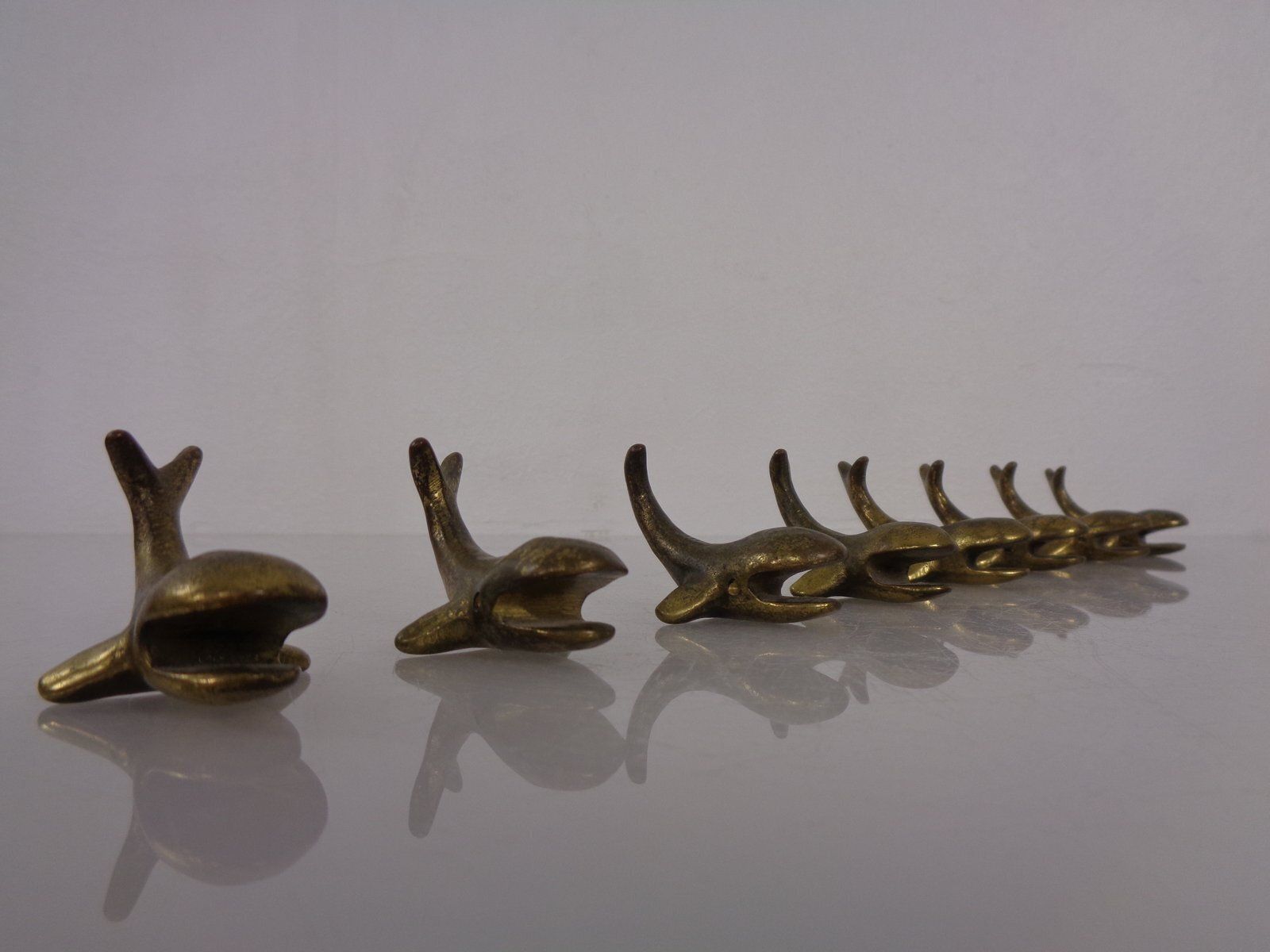 photo for sale Whale Shaped Brass Paperweights Or Knife Rests In The Style Of Walter Bosse, Austria, 1950s, Set Of 4