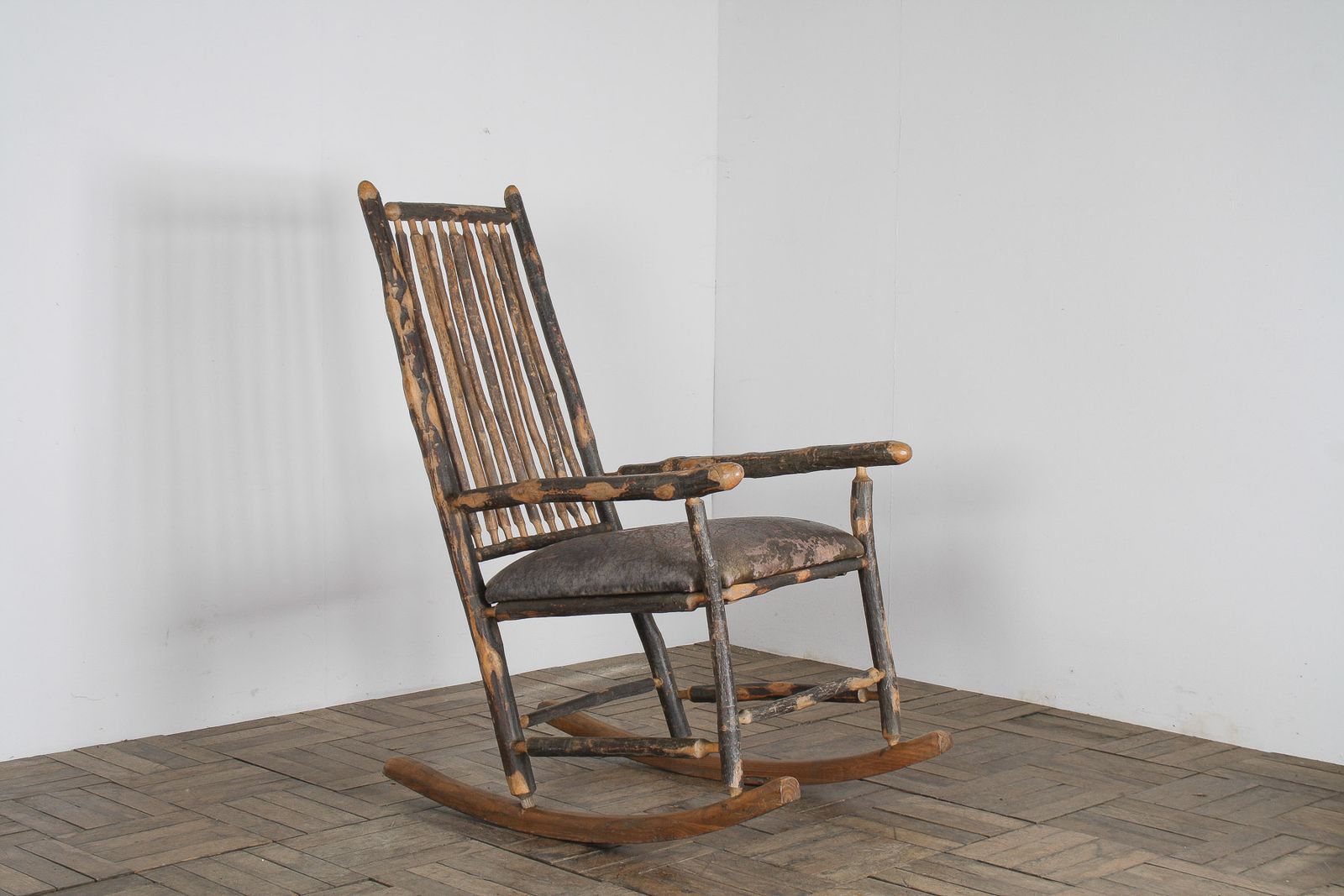 Antique American Stick Back Rocking Chair With Distressed Patina And Leather Seat
