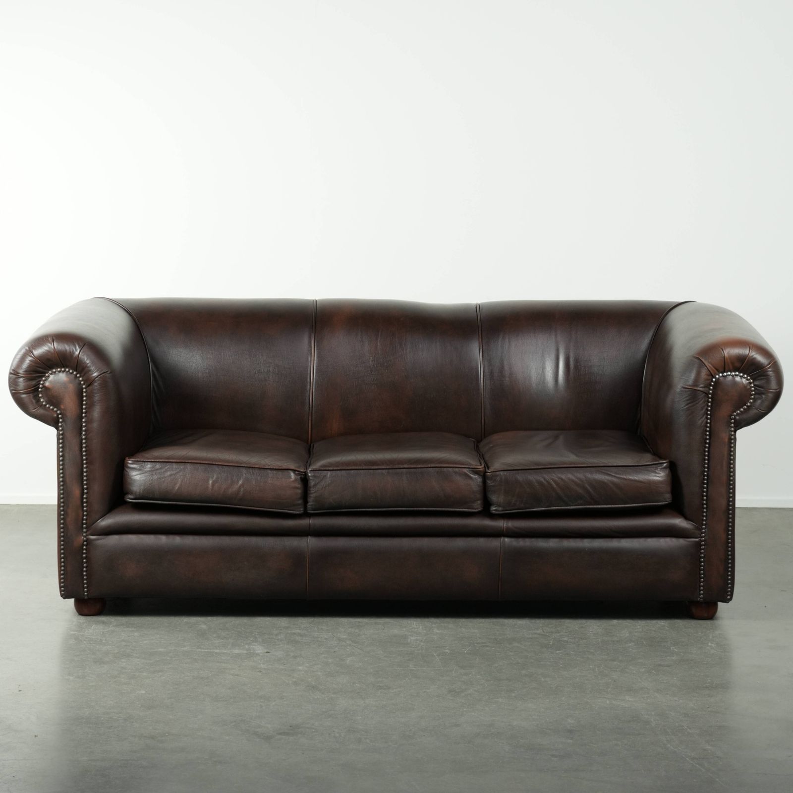 Luxurious Brown Smooth Cowhide Chesterfield Sofa With A Timeless English Look.