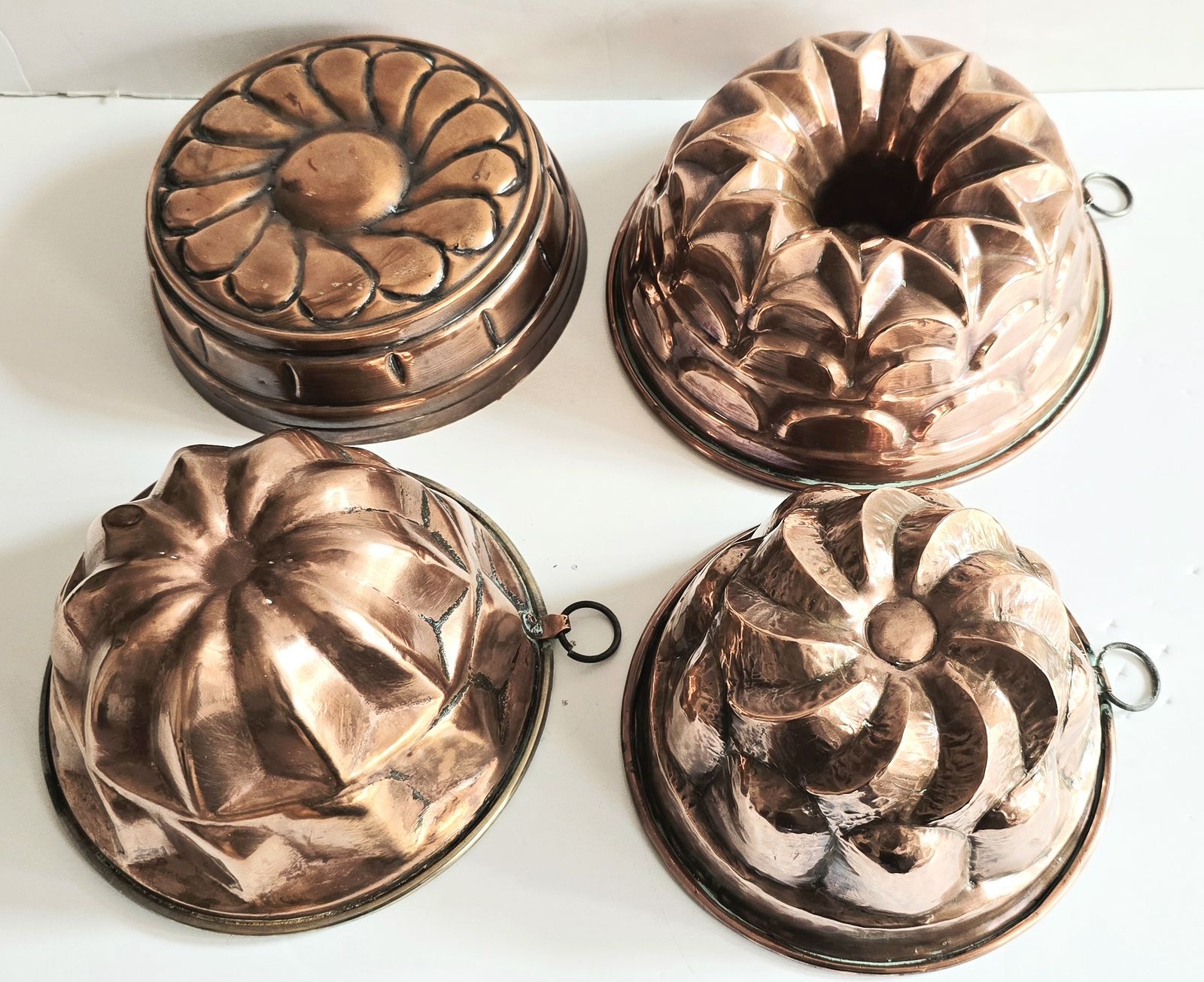 A Set Of Four Large Antique French Copper Cake Moulds, 19th Century.