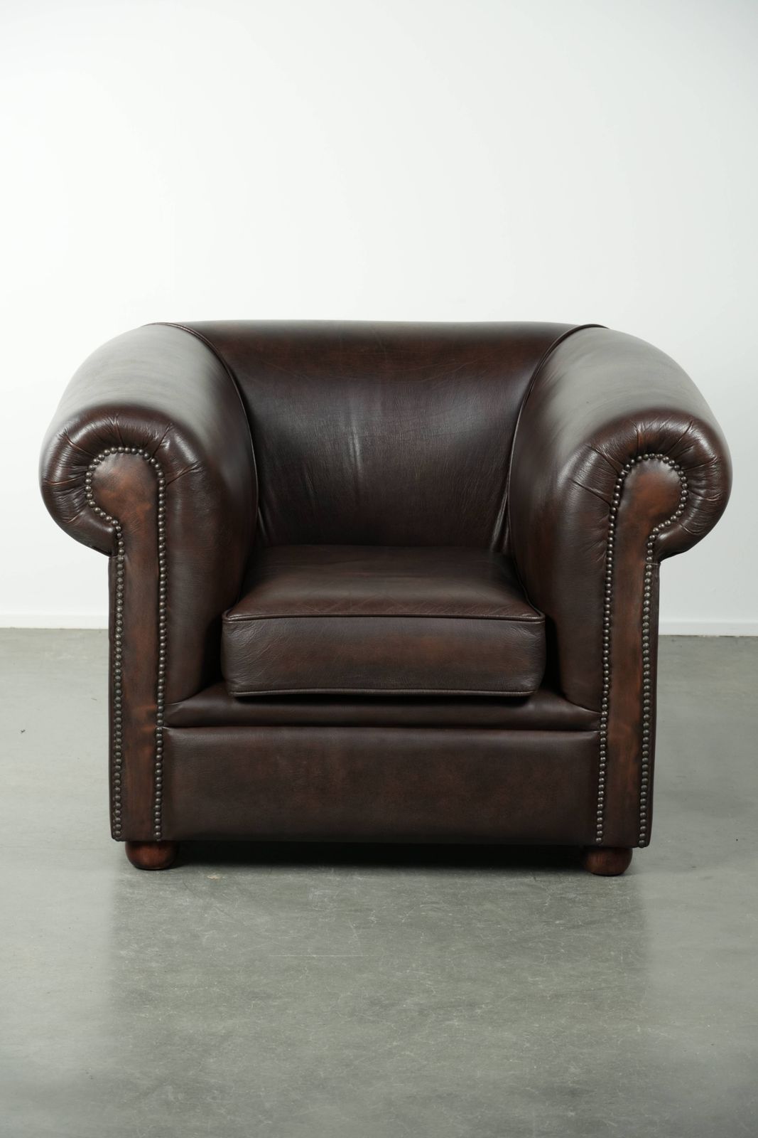 Luxurious Brown Cowhide Chesterfield Armchair With A Timeless English Look. photo furniture