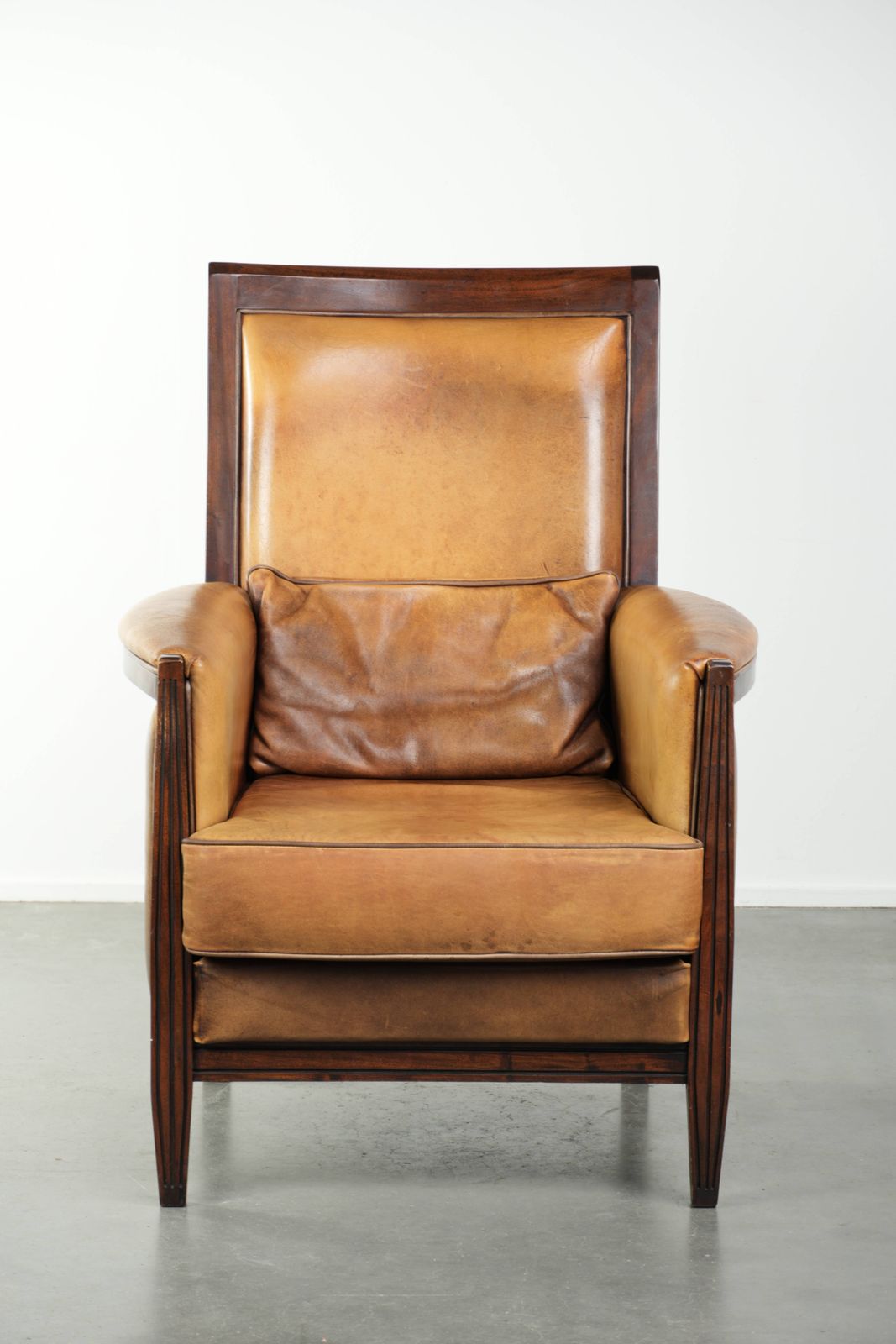 Comfortable Cognac Colored Art Deco Design Armchair Made Of Sheepskin Combined With Wood, With A High Back. photo furniture