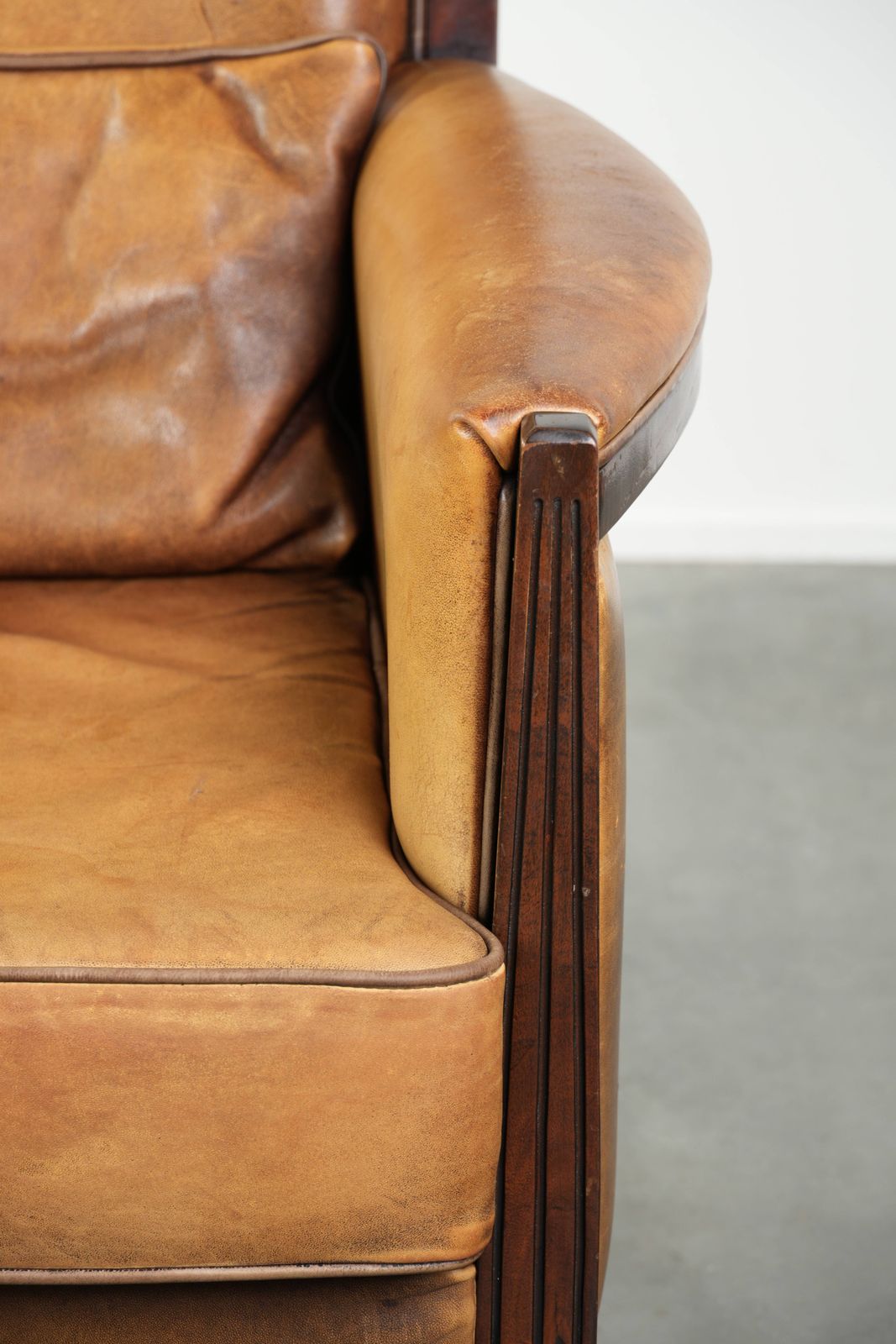 photo for sale Comfortable Cognac Colored Art Deco Design Armchair Made Of Sheepskin Combined With Wood, With A High Back.