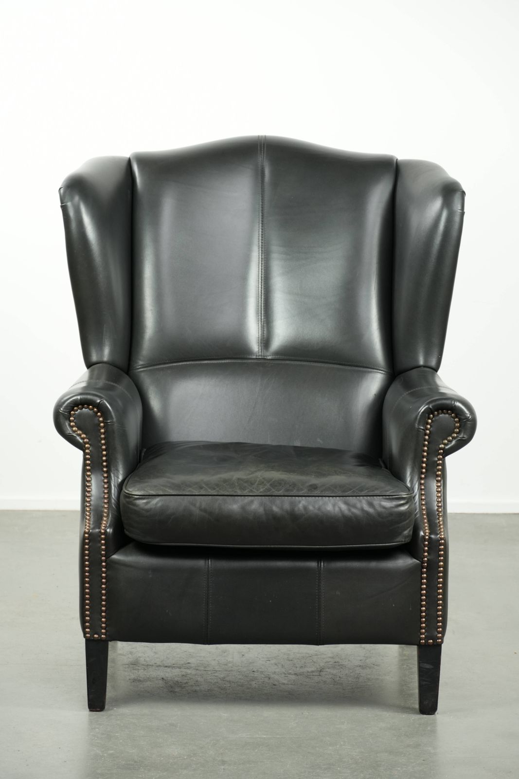Black Cowhide Wing Armchair In A Classic English Style, Finished With Decorative Nails. photo furniture