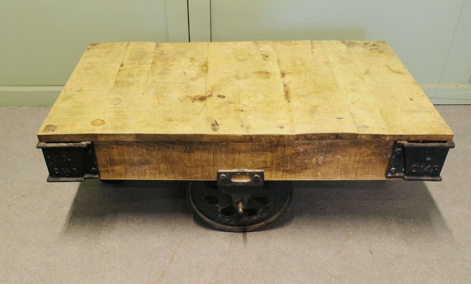 A Unique Wood Framed Industrial Coffee Table The Table Has A Thick Wooden Top photo vinterior