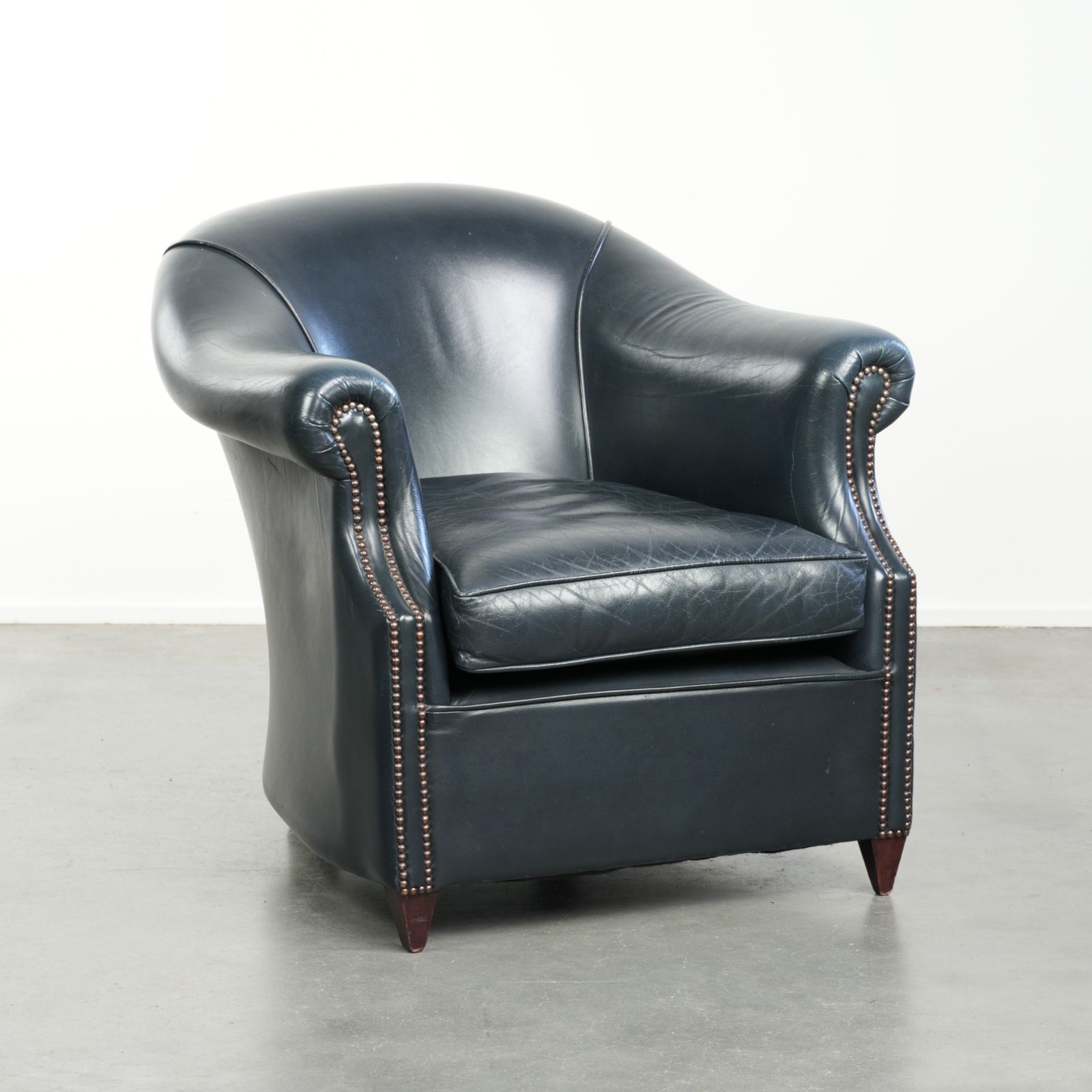 Beautiful And Comfortable Dark Blue Cowhide Leather Club Armchair With A Unique And Timeless Design