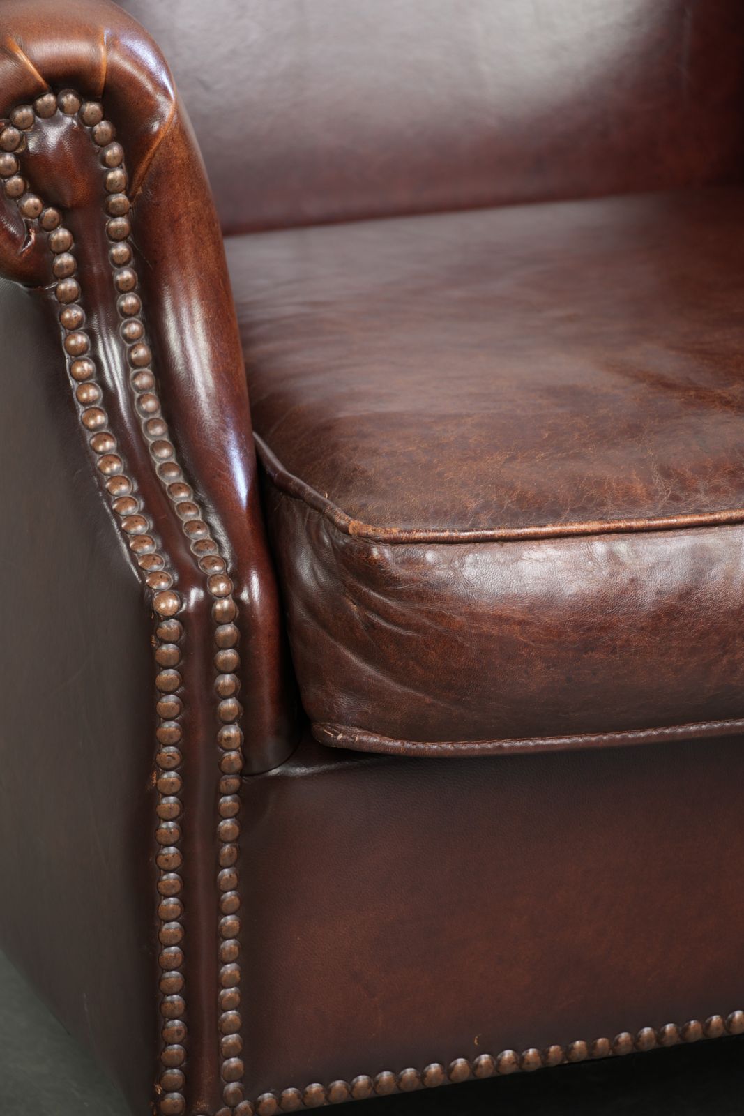 Furniture Elegant Vintage Sheepskin Wing Armchair With A Timeless English Look, Finished With Decorative Nails. photo