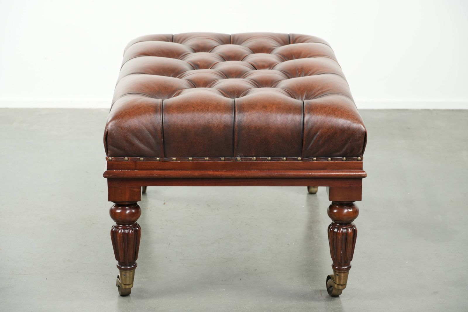 Large Brown Cowhide Chesterfield Ottoman In English Style With Elegant Legs And Brass Casters photo for sale