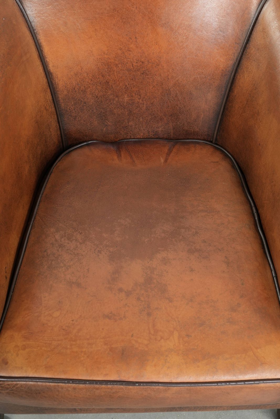 Characterful And Comfortable Sheepskin Club Armchair With A Beautiful Patina And A Refined Finish With Black Piping. photo vinterior